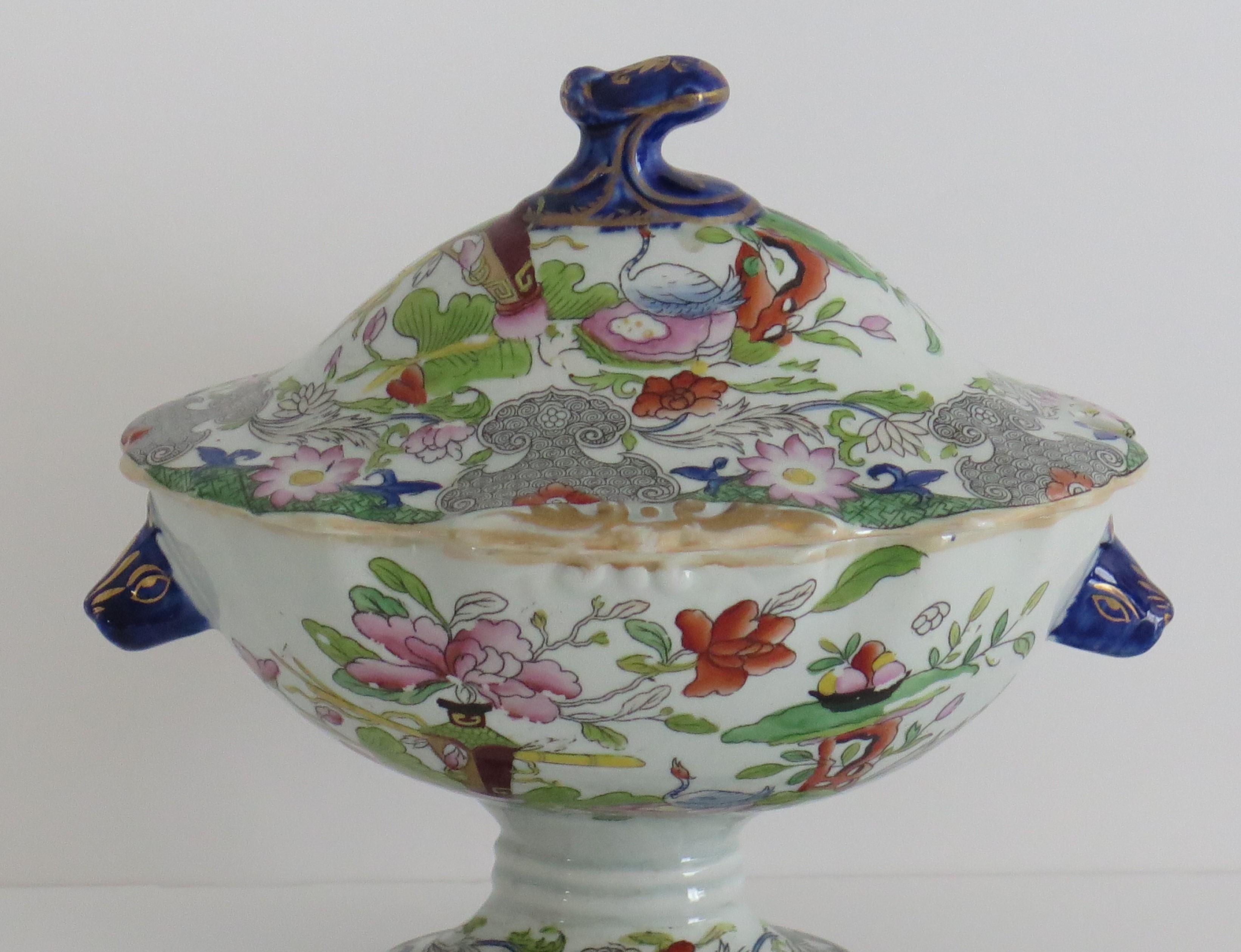 This is a beautiful Ironstone Sauce Tureen, complete with lid, made by Mason's of Lane Delph, Staffordshire, England, during the early part of the 19th century, circa 1820.

This tureen and its lid are well potted in an elegant pedestal shape on a