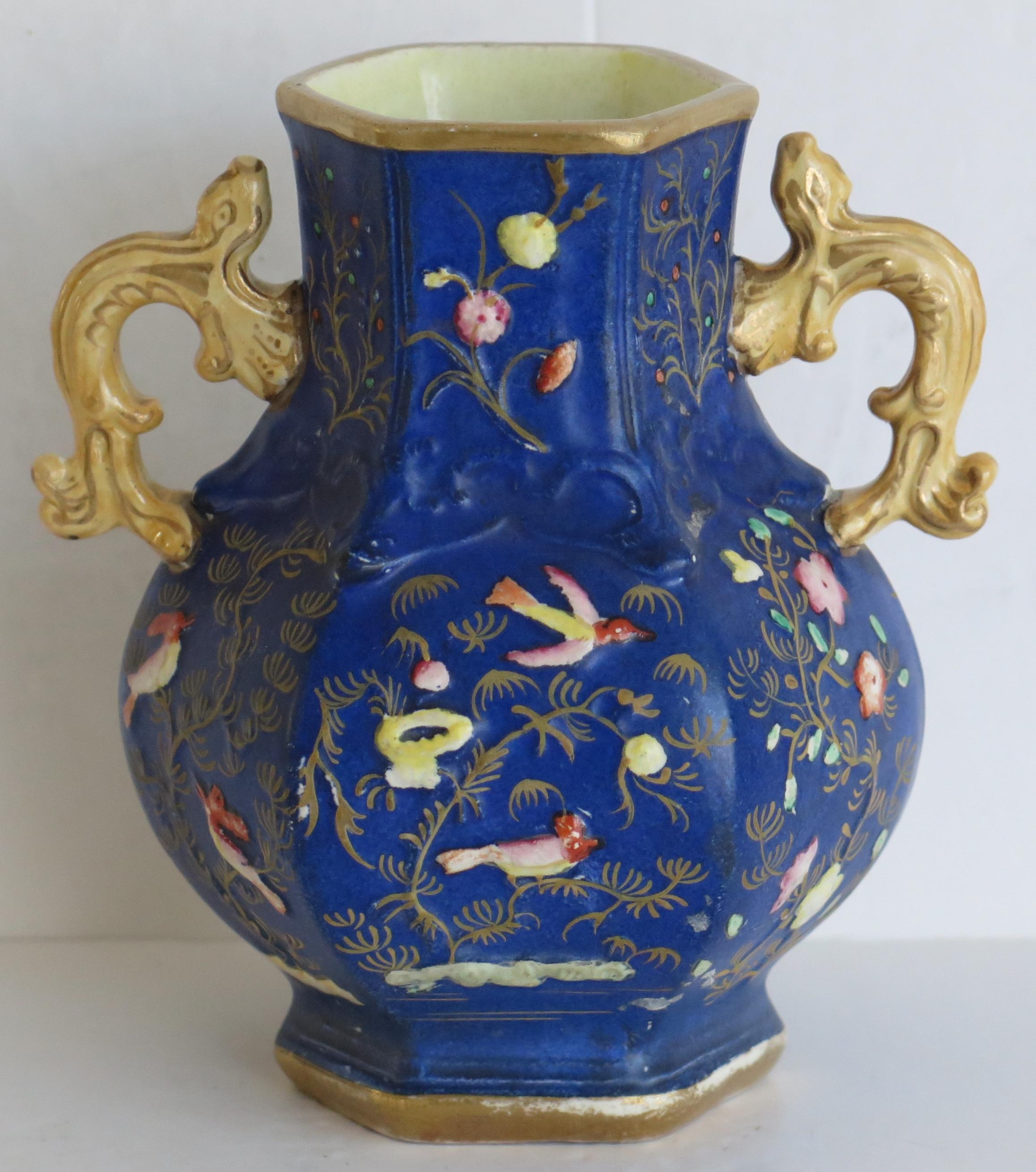 This is a rare ironstone vase, made by the Mason's factory in the early 19th century.

The vase is hexagonal in section with a baluster shape and two salamander handles, one either side.

The vase has a relief moulded pattern which is rare. The