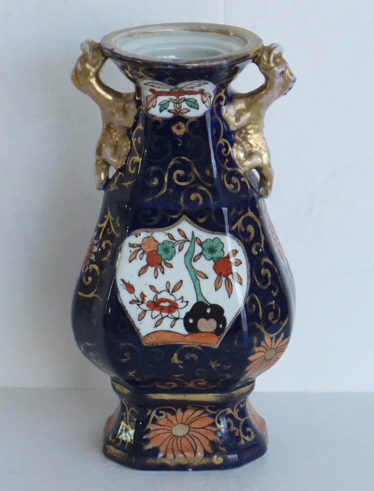 This is an ironstone Vase in the blue Hawthorne and fence and bowl pattern, made by Mason's Ironstone of Lane Delph, Staffordshire, England, during the first half of the 19th century, circa 1825-1835.

The vase has a baluster shape with two
