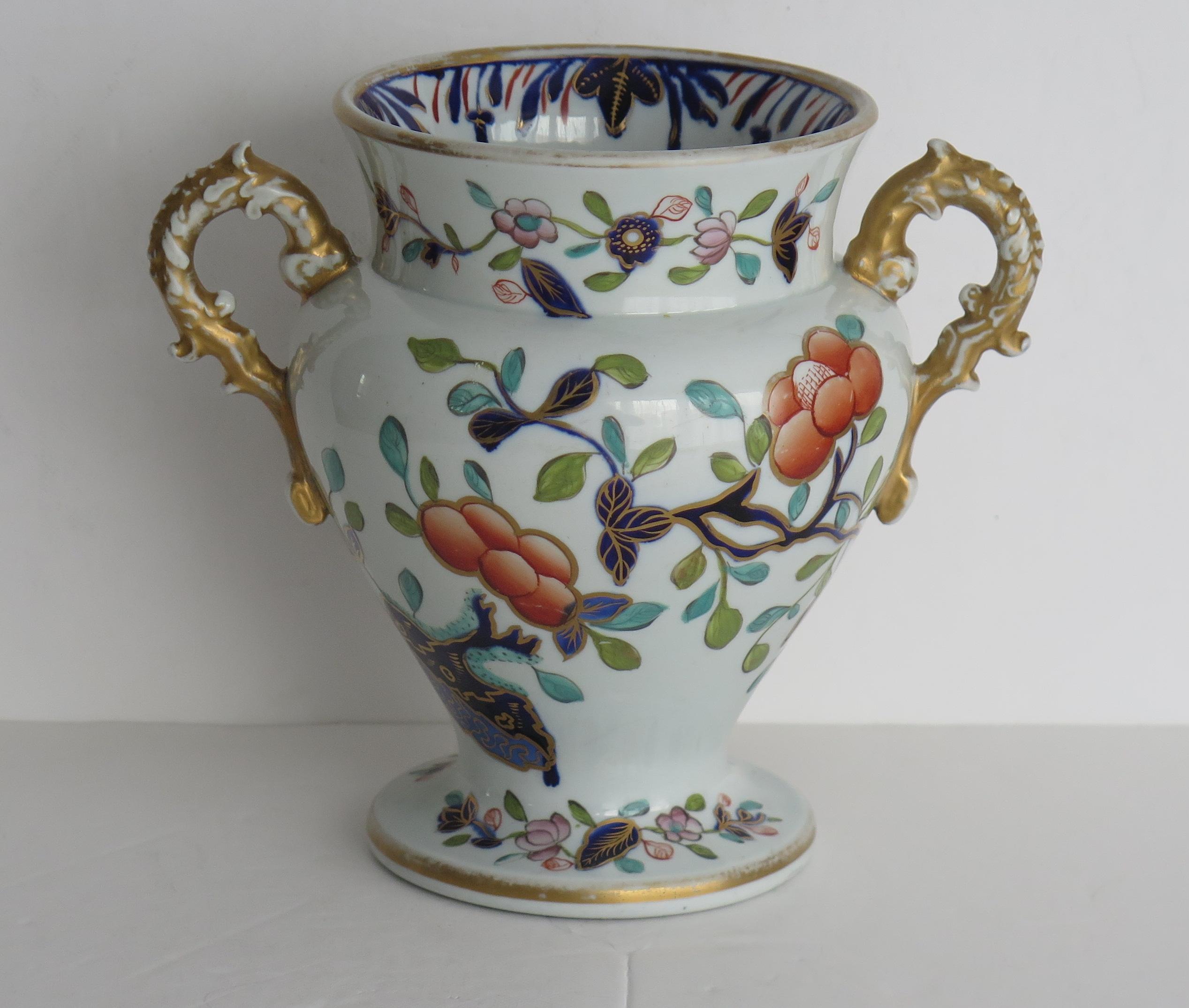 This is a rare, very early ironstone vase, in a typical hand painted Japan pattern, made by the Mason's factory in the early 19th century, Circa 1815.

The vase has a baluster shape raised on a circular foot with two moulded, spurred side handles