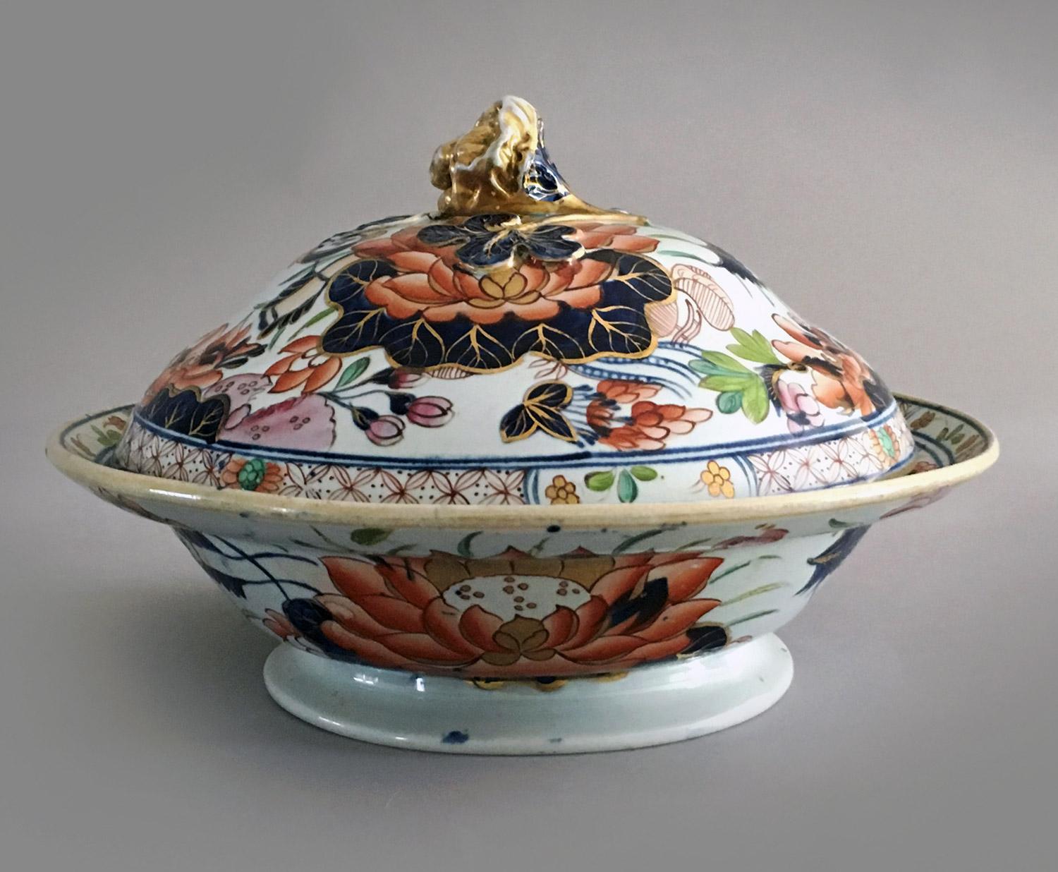 Antique Mason’s ironstone “Water Lily” pattern partial dinner service, decorated with the central theme of a large water lily surrounded by various flowers and foliage with a diaper border of red stylized flowers, in a lushly polychrome Imari