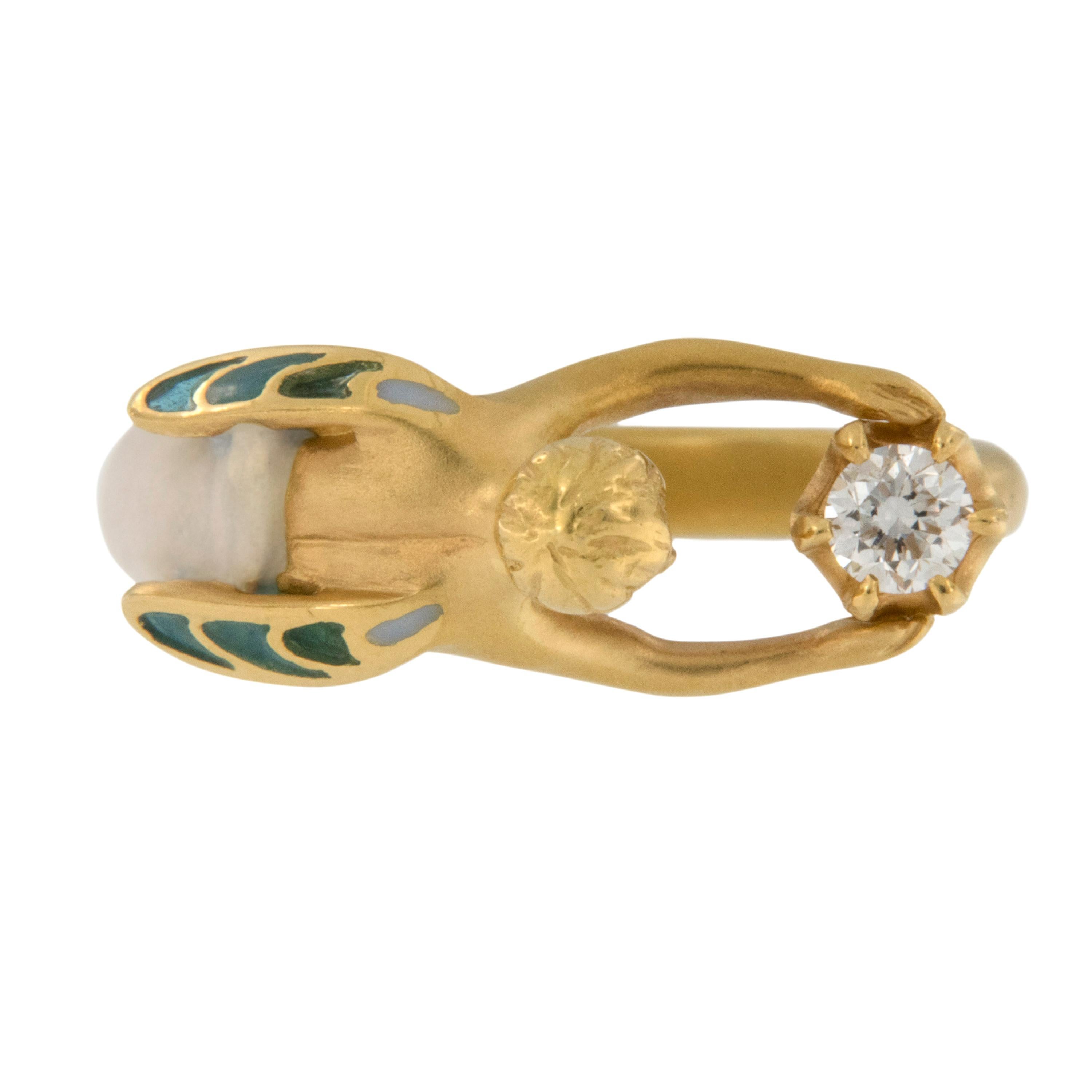 Masriera is a company world-renowned for their amazing enamel work & Art Nouveau reproductions. This 18kt yellow gold Angel Of The Morning
 ring with “plique-à-jour” and “basse taille” fired enamel depicts an angel holding up a brilliant cut diamond