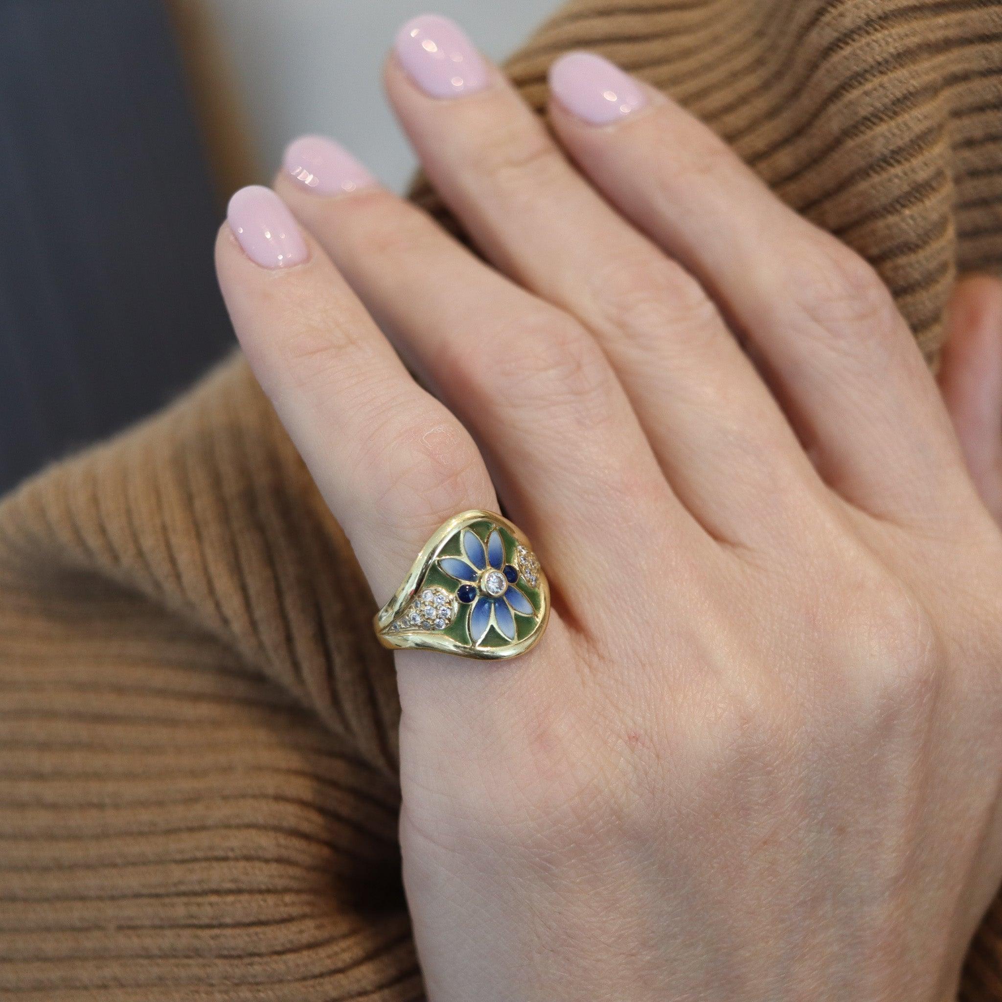 An art nouveau enameled ring designed by Masriera.

This is a beautiful colorful ring created in Barcelona Spain by the jewelry designer Gloria Masriera for Masriera. This beautiful ring has been crafted with art nouveau revival patterns in solid