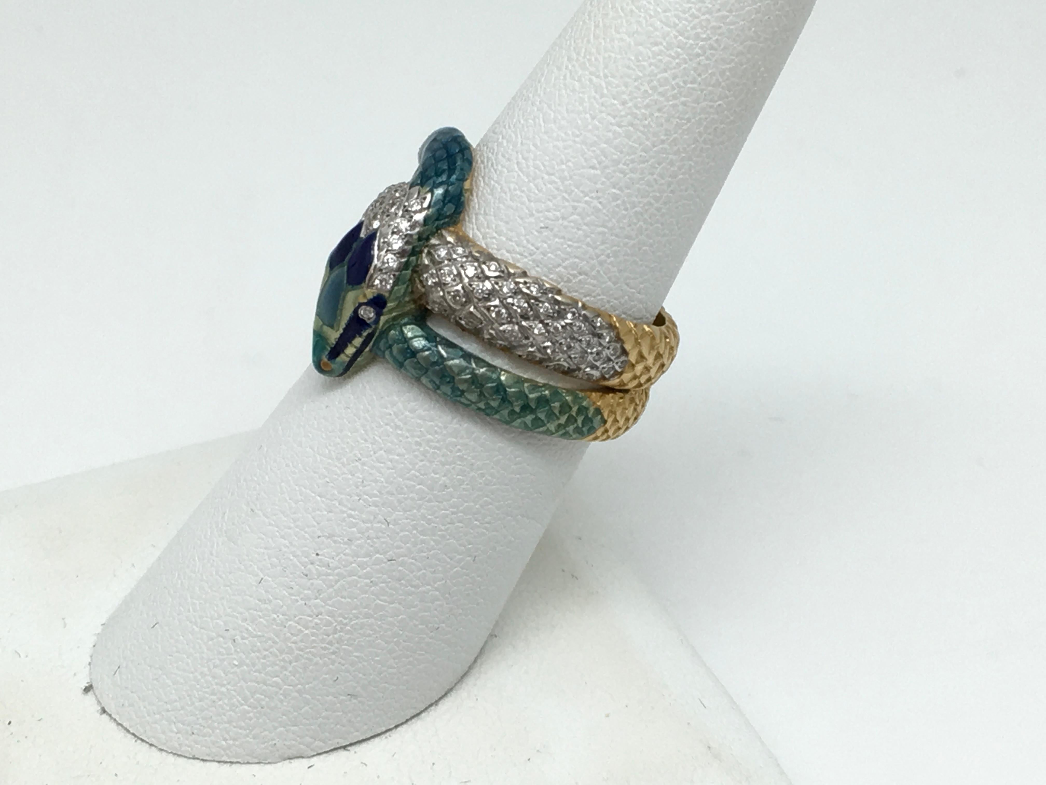 Masriera snake motif ring in 18KT Yellow gold.
The ring is blue and green Enamel with 94 Round  Brilliant Cut Diamonds for a total combined weight by measure of approximately .50 Carat.
The ring carries an additional stamp in the shank G-2267-G
