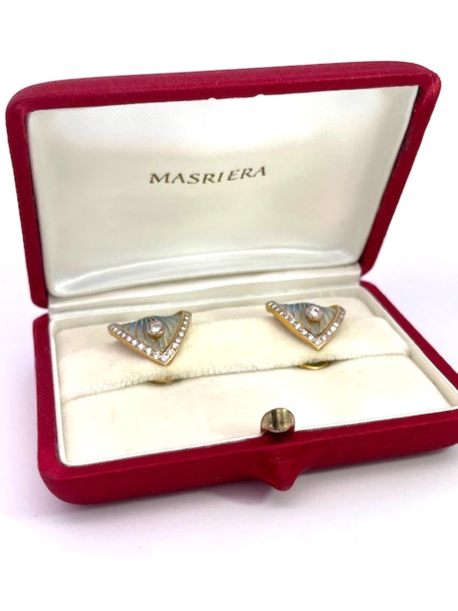 These Masriera earrings are just lovely and delightful.
They are plique a jour the specialty of the firm Masriera.  These earrings are in shades of blue and grey with a center Diamond and the edges of these triangle shaped earrings are studded in