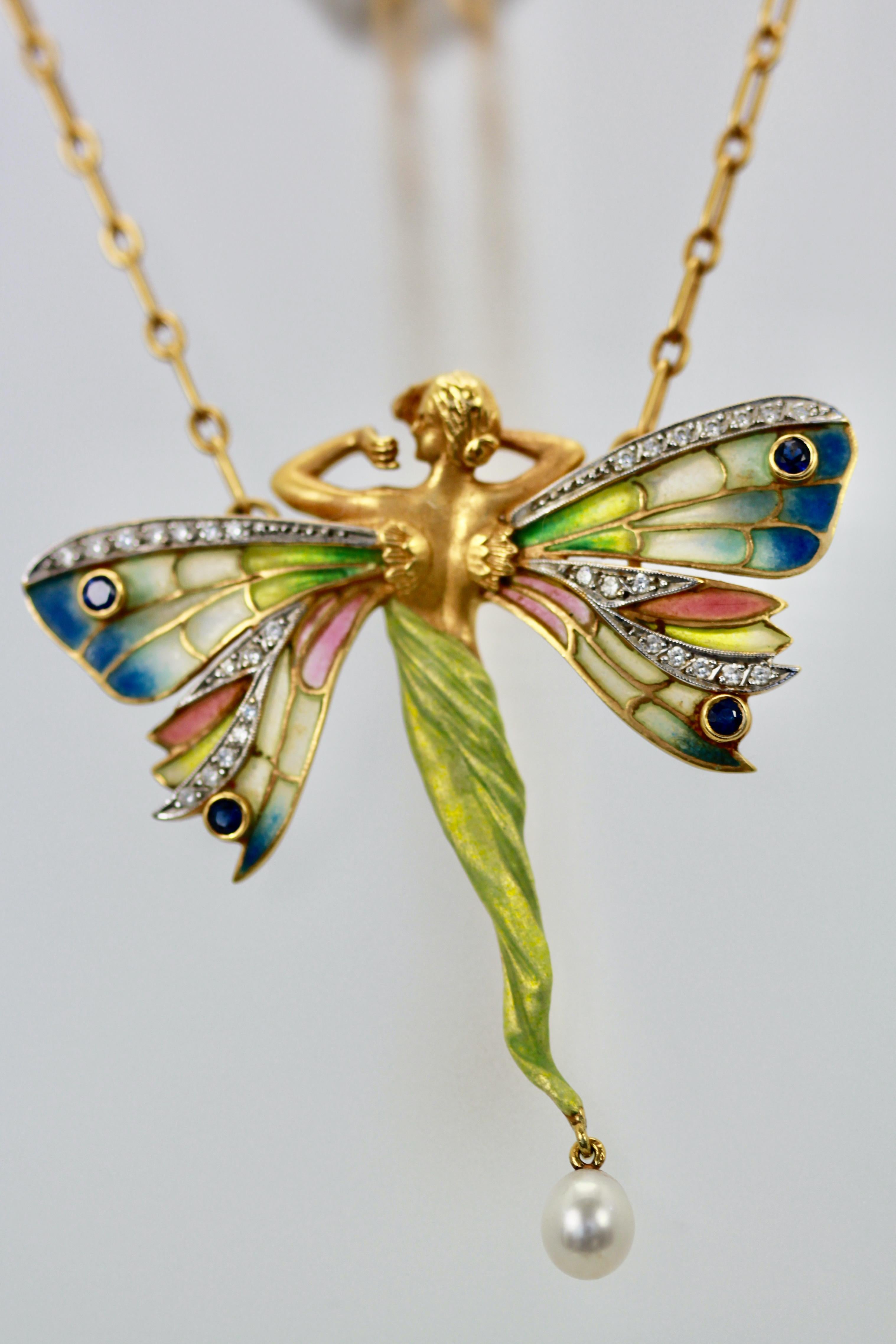 This Masriera piece is very special, it is the most beautiful of all these lady pendants Masriera makes.  The plique a jour wings are enameled in gorgeous shades of Blues and Greens with a little pink and a bit of Yellow.  The wings have Diamonds