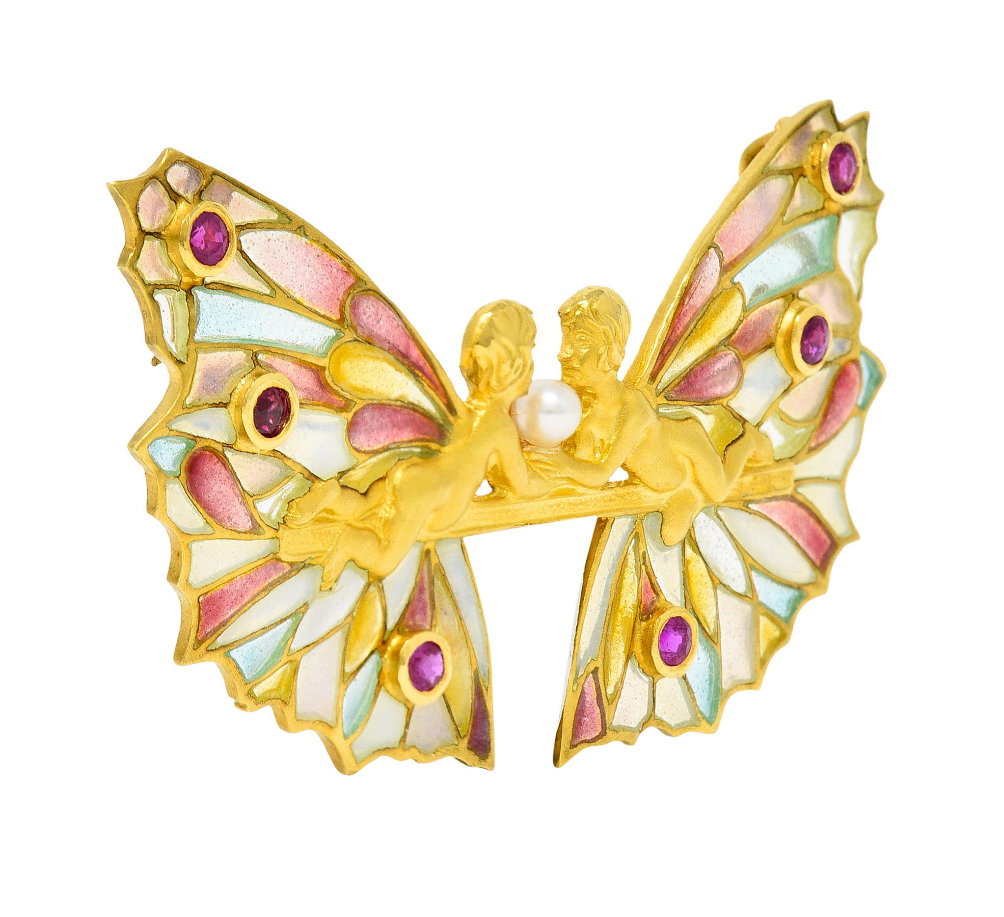 East to West pendant brooch depicts two mirrored fairy figures

With highly rendered matte gold bodies and elaborate plique-a-jour enamel wings

Glossed with semi-transparent pastel blue, pink, green, and yellow enamel - exhibiting no