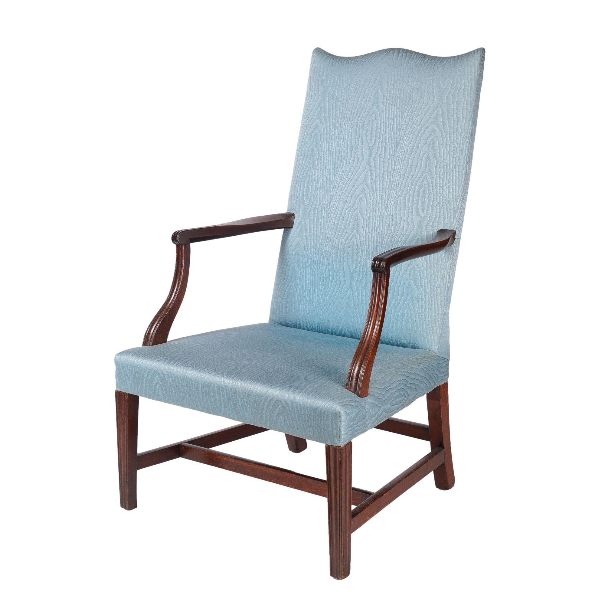 Upholstered Martha Washington lolling chair with serpentine crest rail. The chair frame is mahogany with Northern White pine and maple secondary woods. The chair has been stripped of three layers of upholstery, including the removal of tacks. The