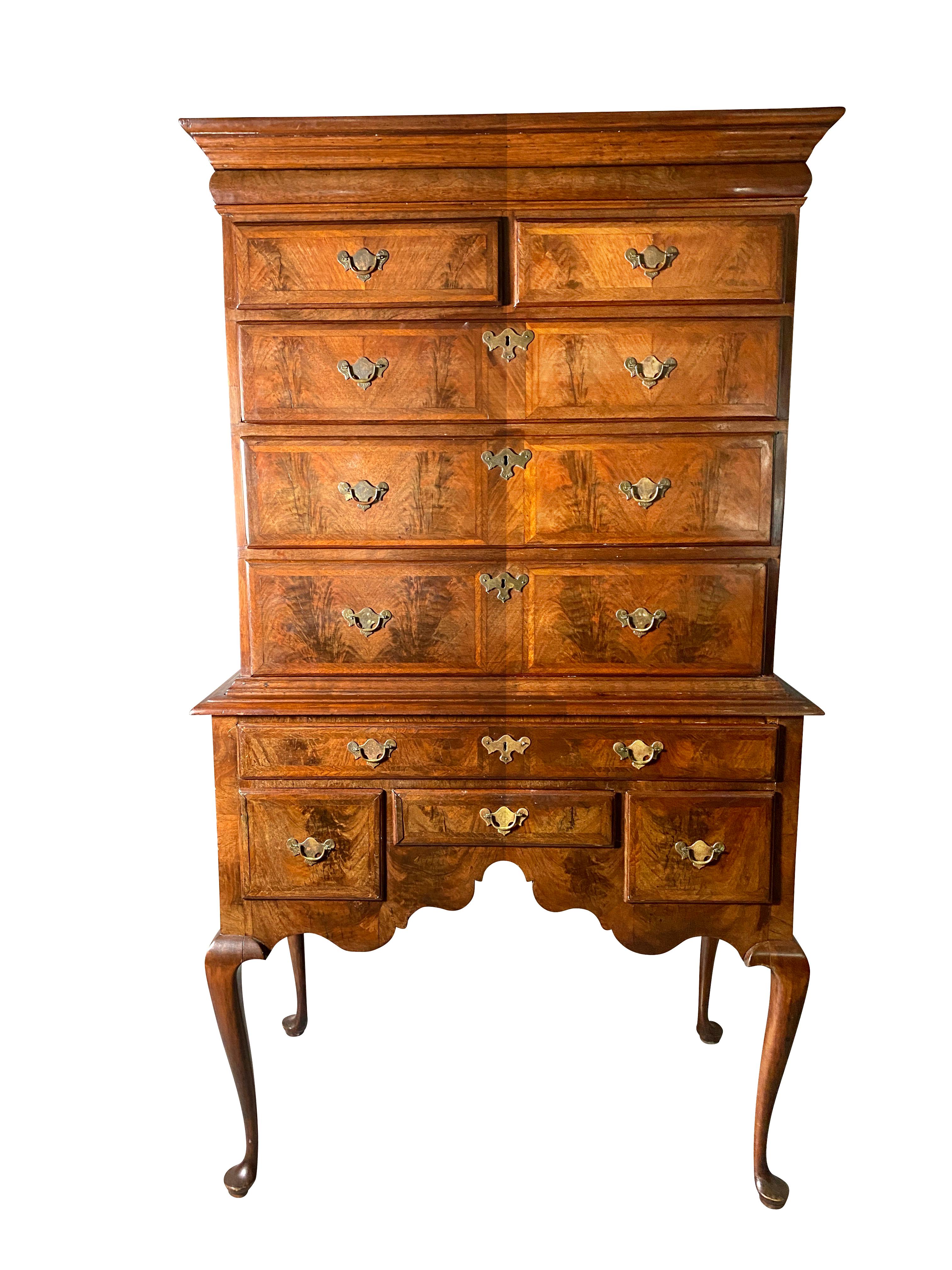 In two parts , the top with hidden cushion drawer in cornice over four drawers , the base with a long drawer over three small drawers , shaped skirt and raised on cabriole legs ending on pad feet. This piece is from the North shore coastal towns