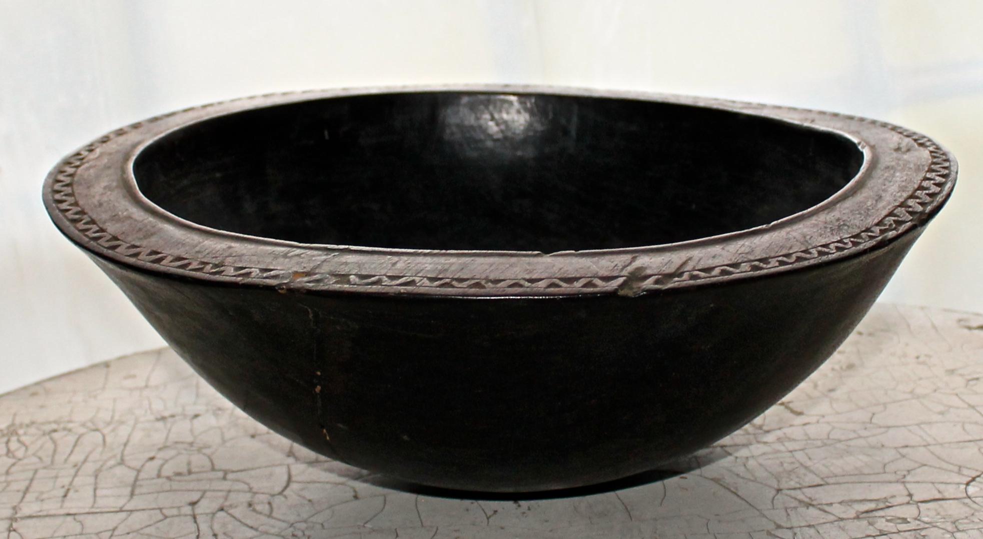 Ornately decorated rim, with abstract carving on bottom. Beautiful rich patina.