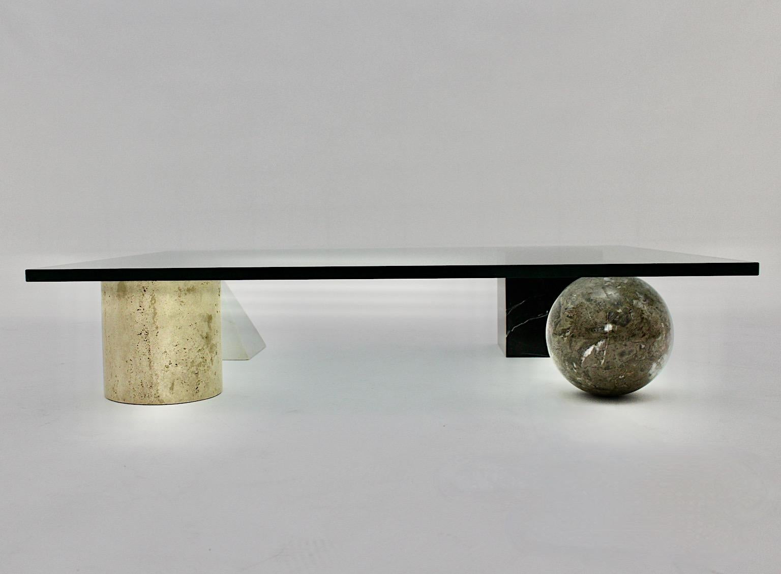 Modern vintage low sofa table or coffee table from marble, travertine and glass model Metafora by Massimo and Lella Vignelli 1970s Italy.
Iconic low sofa table composed of 4 geometric elements as feet from black marble rectangular element, white