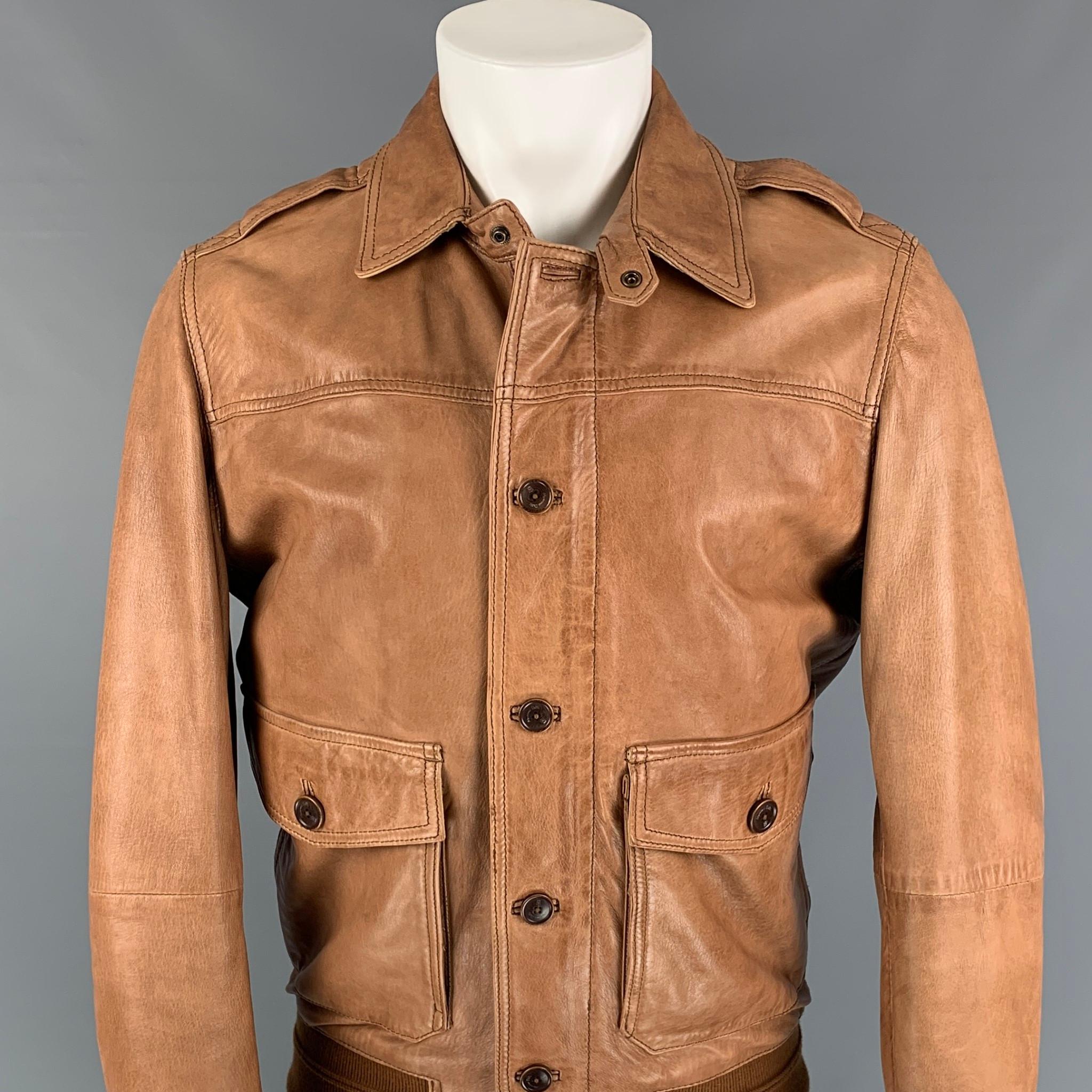 MASSIMO DUTTI jacket comes in a tan leather with a full liner featuring a ribbed hem, patch pockets, and a zip and button up closure. 

Very Good Pre-Owned Condition.
Marked: M

Measurements:

Shoulder: 17.5 in.
Chest: 40 in.
Sleeve: 27 in.
Length: