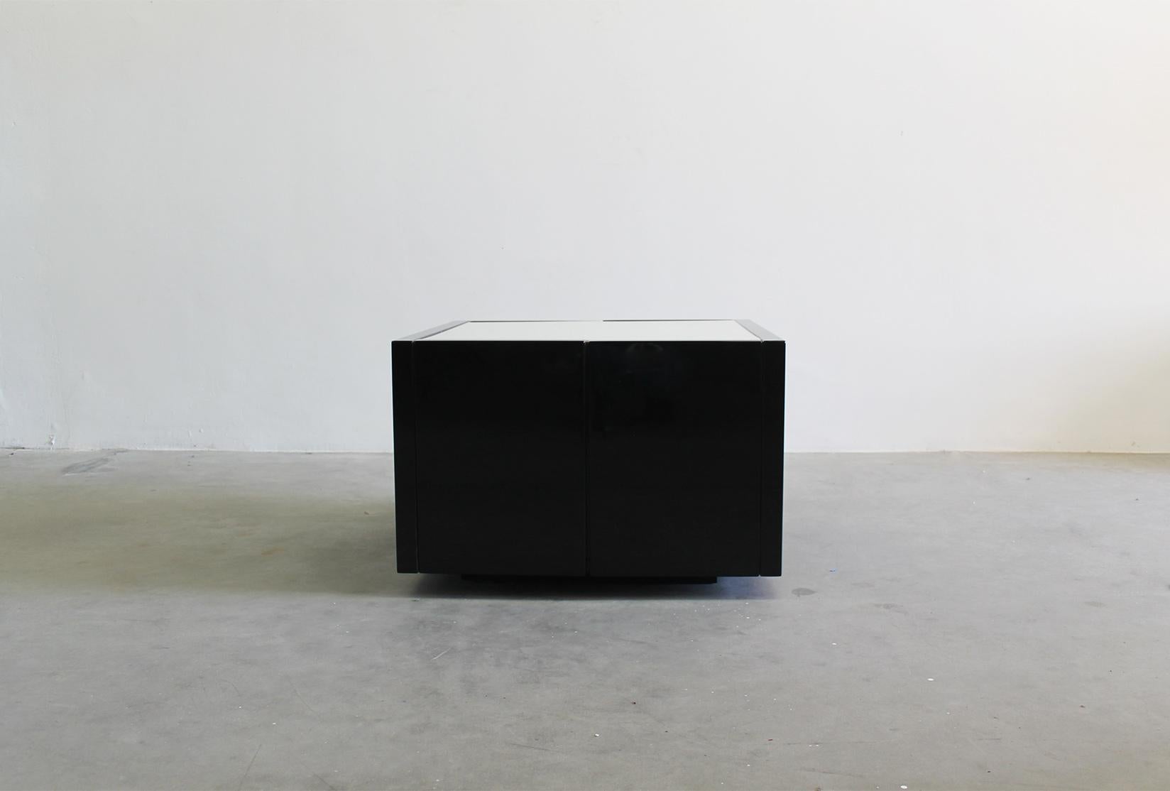 Saratoga luminous side table/cabinet bar in black lacquered wood, this piece presents two openable opposite doors and inner shelves. 

Designed by Massimo and Lella Vignelli and produced by Poltronova in the 1960s 

Massimo Vignelli was a celebrated