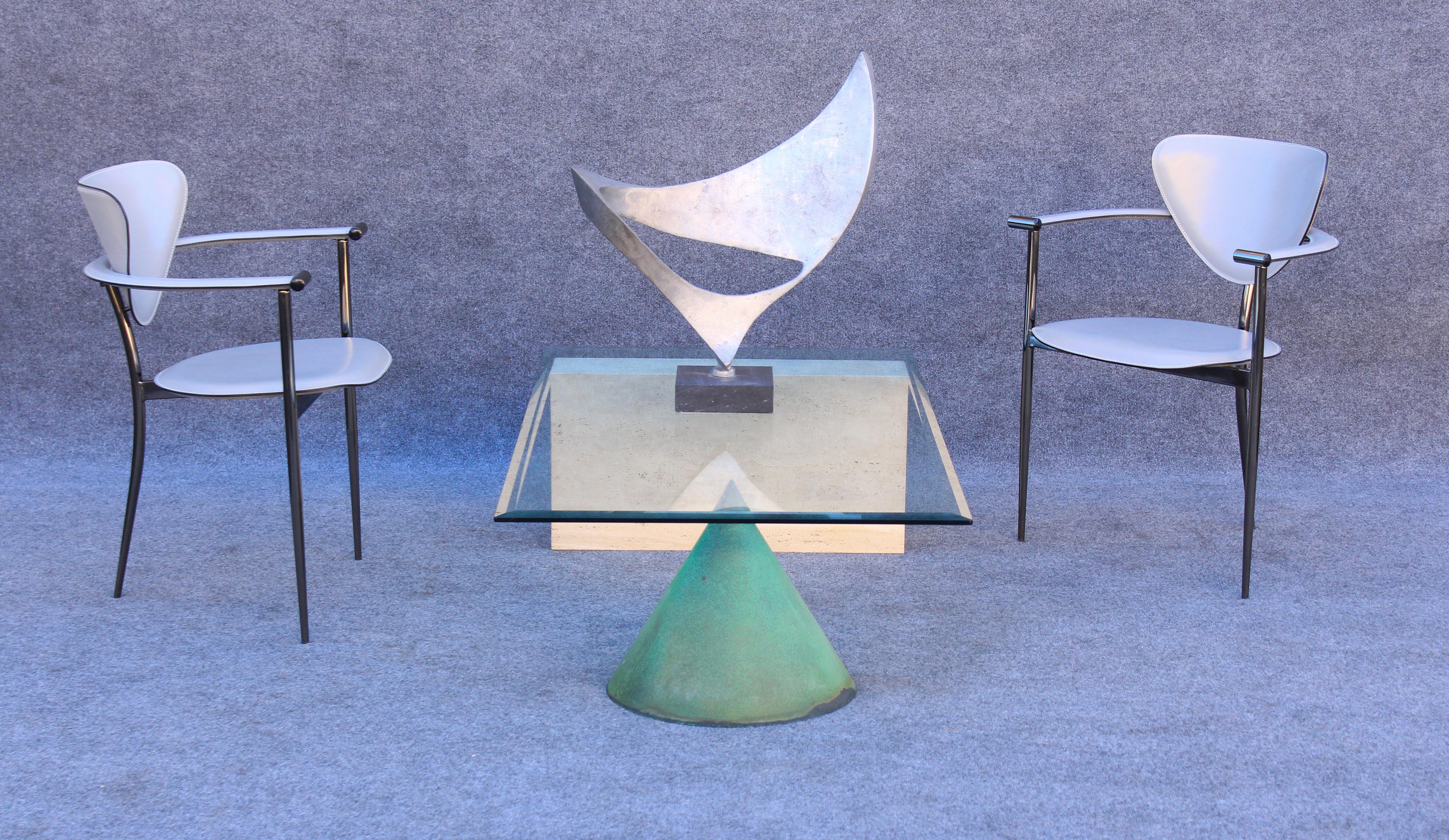 Designed by Italian architects Massimo & Lella Vignelli, this table was made in the 1970s by Casigliani. Different versions of this table are out there, but this particular model is called the 'Kona' and is made of a metal cone and a single block of