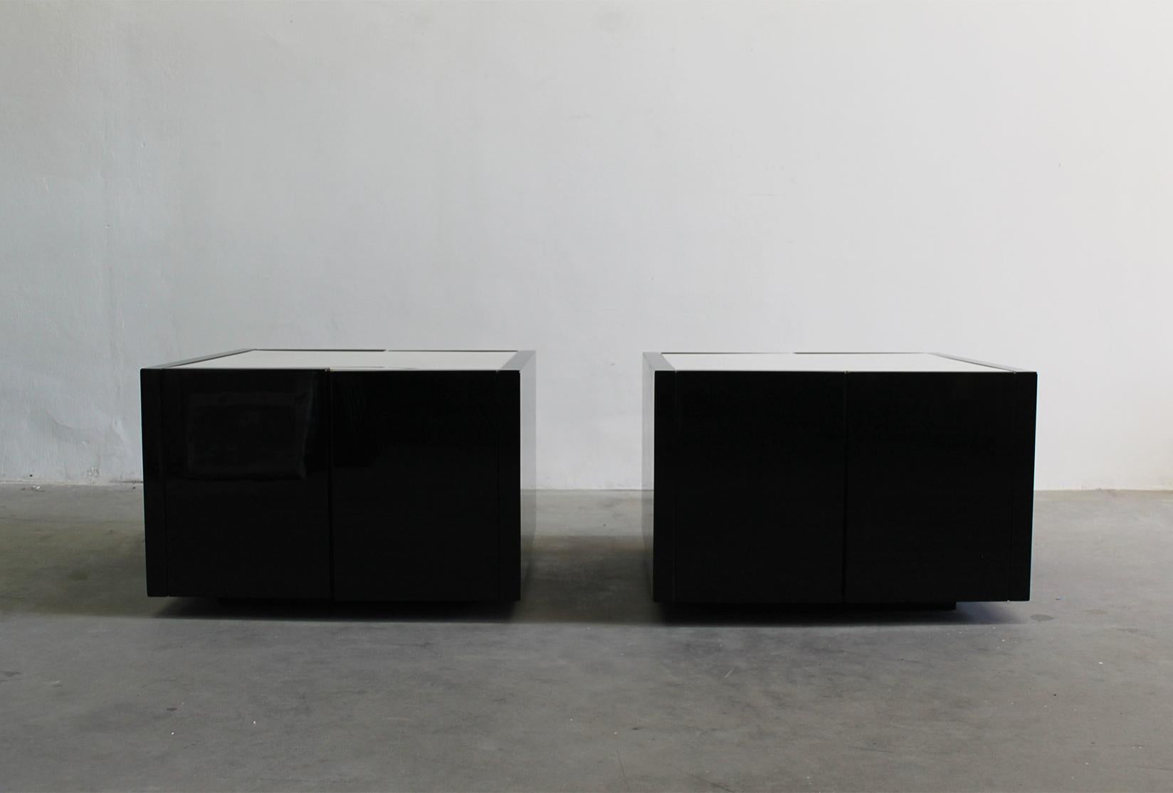 Set of two luminous side table/cabinet bar in black lacquered wood, these piece presents two openable opposite doors and inner shelves. 

Designed by Massimo and Lella Vignelli and produced by Poltronova in the 1960s 

Massimo Vignelli was a
