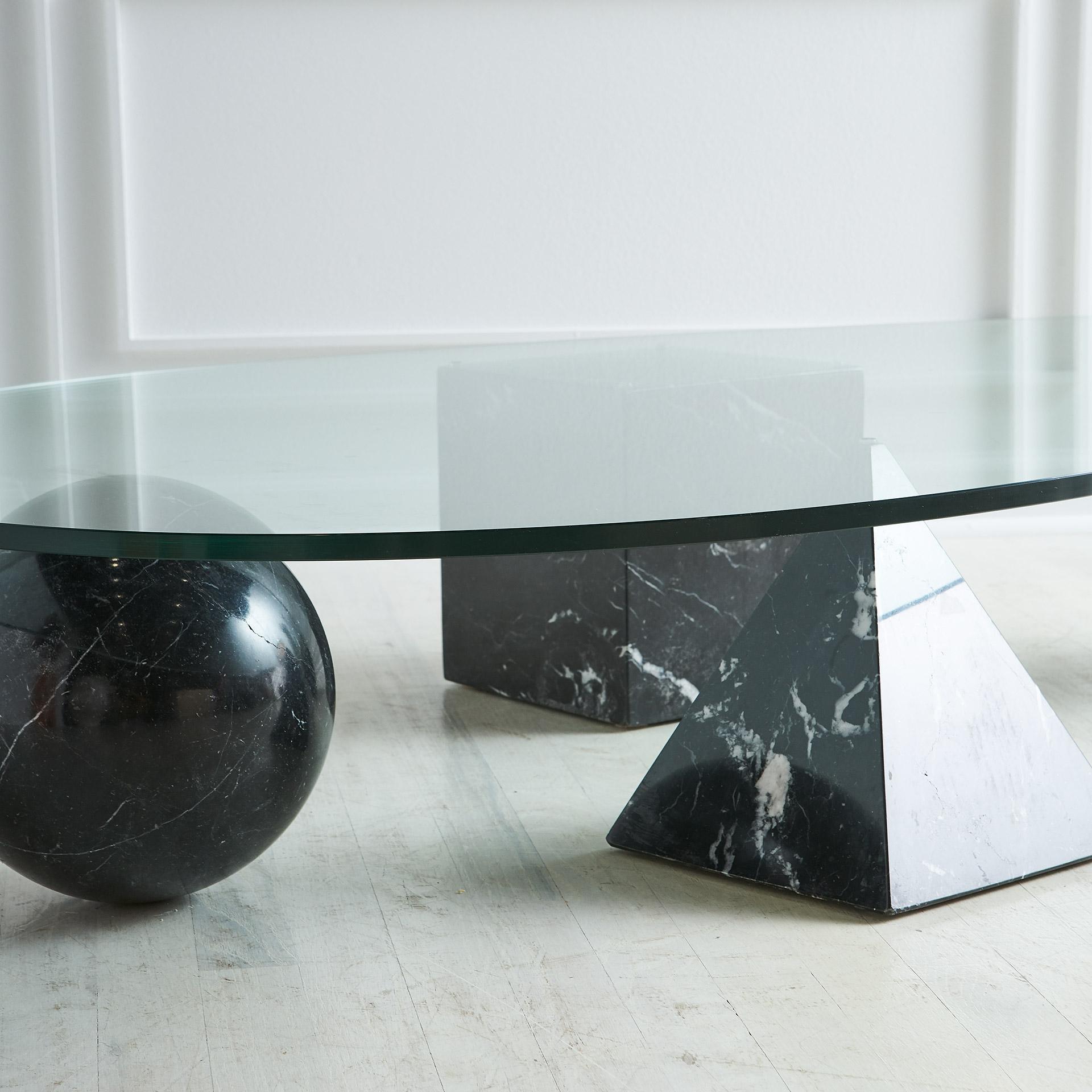 Massimo Vignelli for Martinelli Luce. Italian, late 1970s. This table features four geometric shapes in solid Nero Marquina Marble and is completed with a kidney shaped glass top. The four geometric pieces can be freely positioned for a variety of