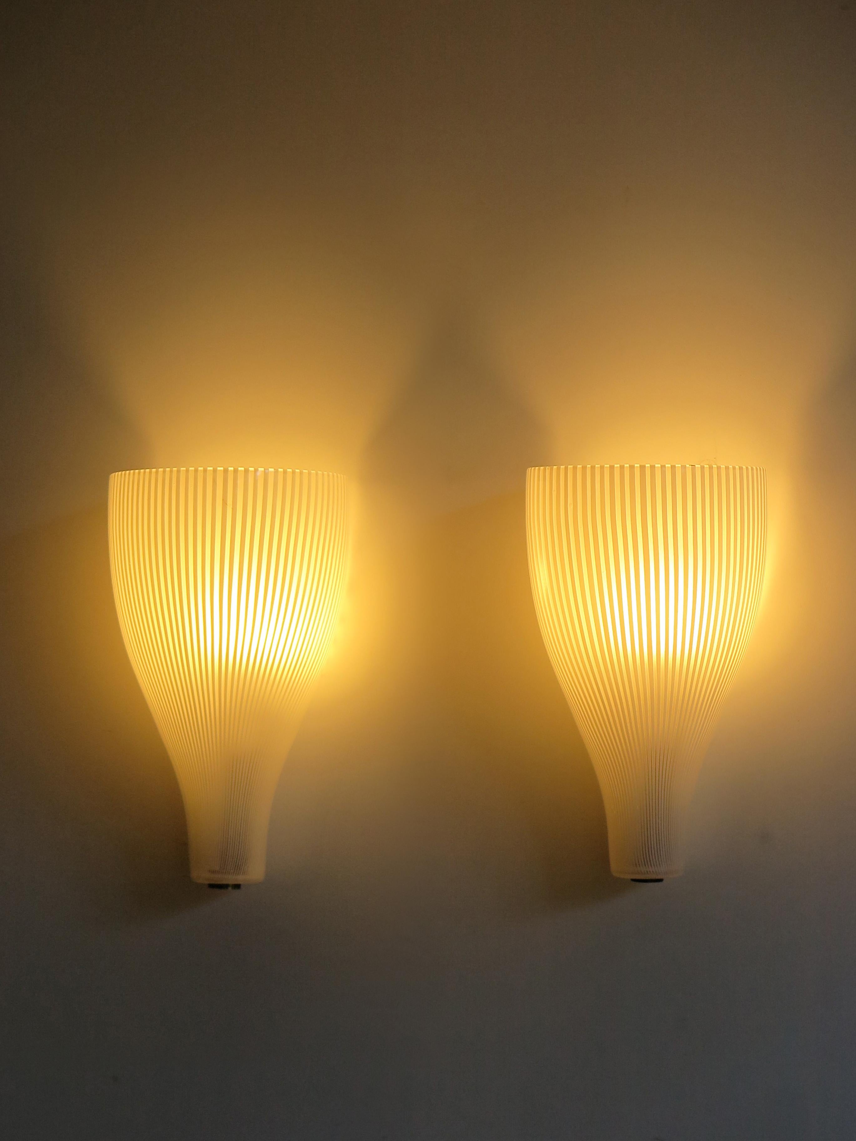 Italian glass wall lamp or sconces set designed by Massimo Vignelli for Venini, Murano, midcentury design, 1950s.

Please note that the lamps are original of the period and this shows normal signs of age and use.
The glasses have no cracks or