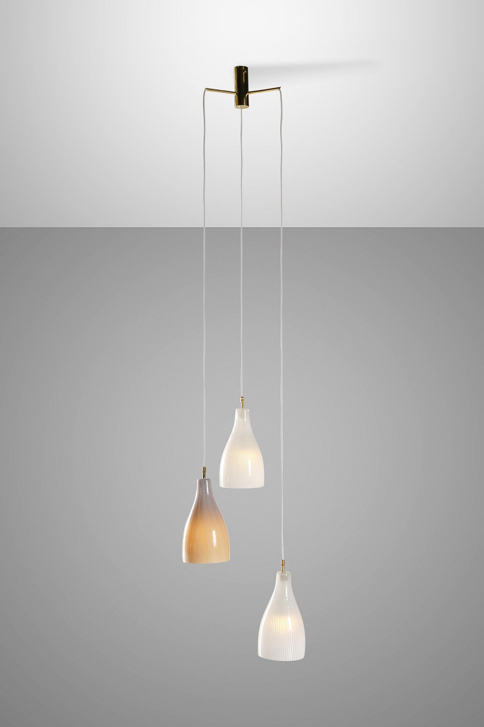 This mid-century pendant lamp was designed by Massimo Vignelli for Venini in the 1960s and features 3 exceptionally refined Murano glass diffusers mounted on a brass structure.