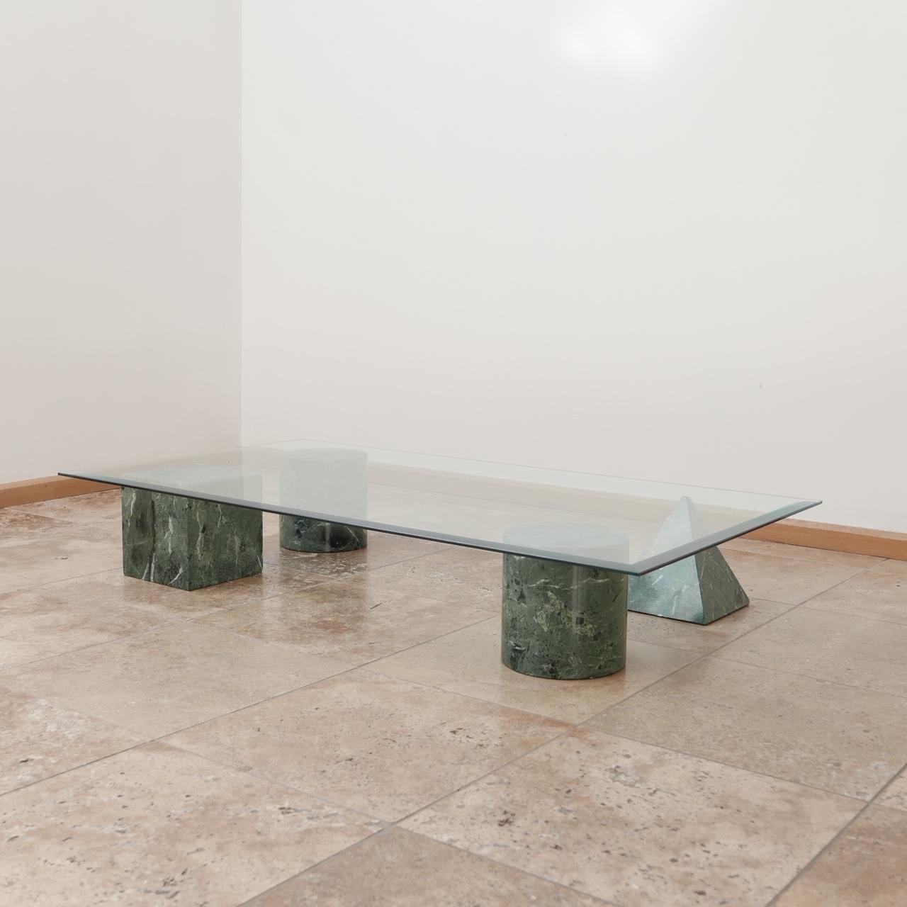 A marble and glass coffee table by esteemed Italian designers, Massimo and Lella Vignelli, 

circa 1970s, Italy. 

'Metaphora' model. 

Formed from veined green marble geometric shapes. 

Beveled glass top. Obviously the glass can be