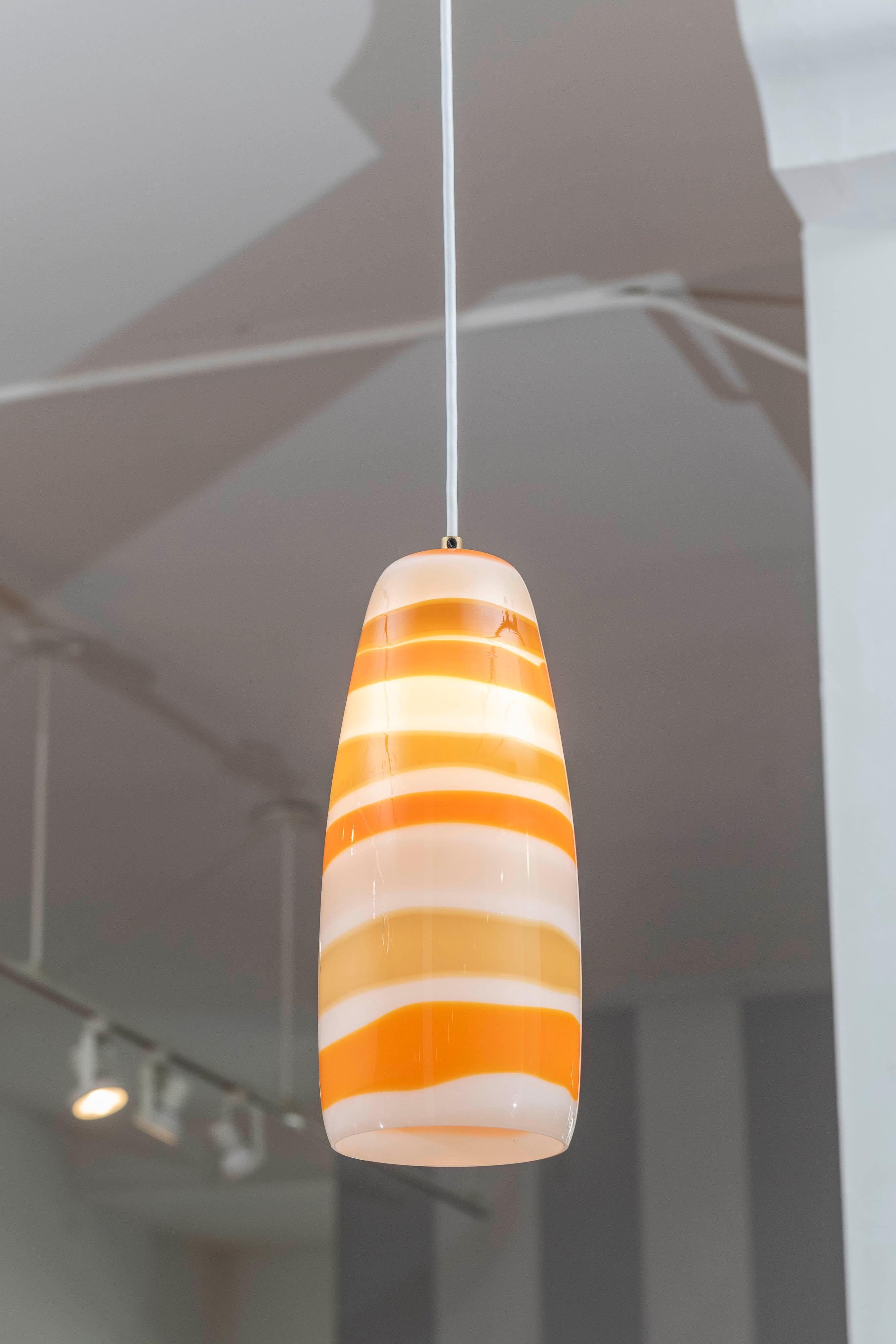 Lampe à suspension conçue par Massimo Vignelli pour Venini, Italie. Un design frappant et des couleurs inhabituelles dans cet exemple de sa signature emblématique de lampe à suspension en verre tourbillonnant. L'installation électrique a été refaite