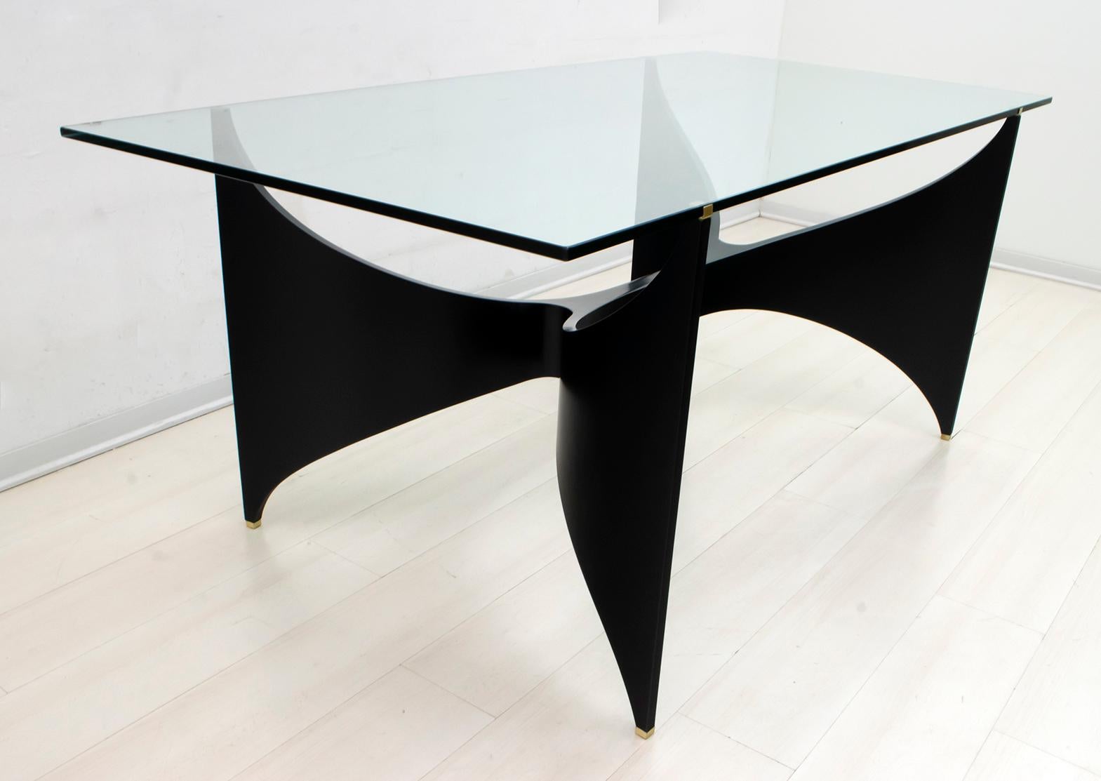 Massironi Manfredo
Rectangular table with lacquered wood structure, brass terminals, glass top.

Manfredo Massironi was an Italian artist and architect. Born in Padua in 1937. After studying architecture in Venice, in 1959 he was one of the