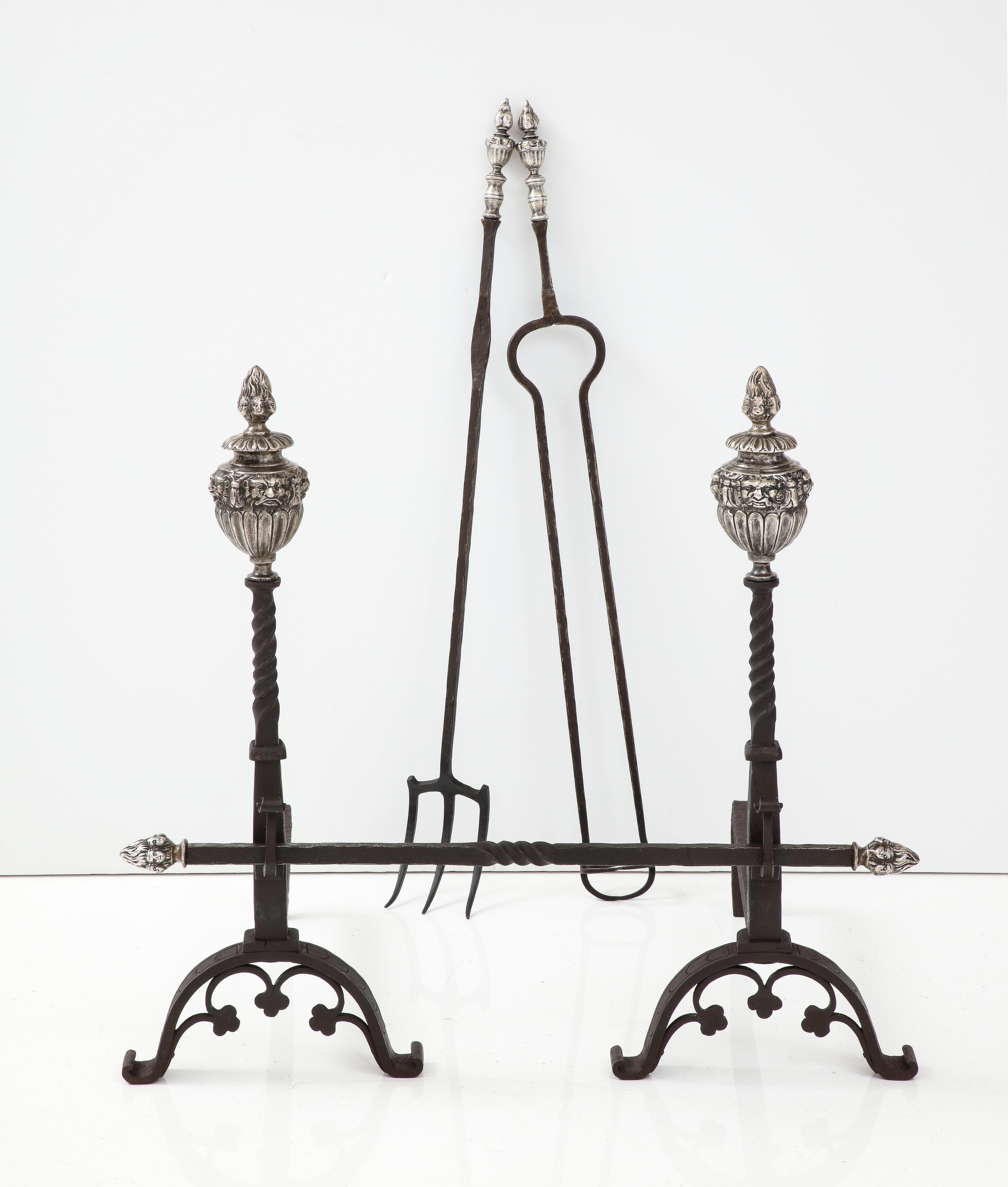 Stunning set of 1890's large andirons with matching fireplace tools, made of solid iron and bronze the finials have been nickel plated, all the finials have faces decorative motif, these pieces come from a mansion in Southampton, NY in vintage
