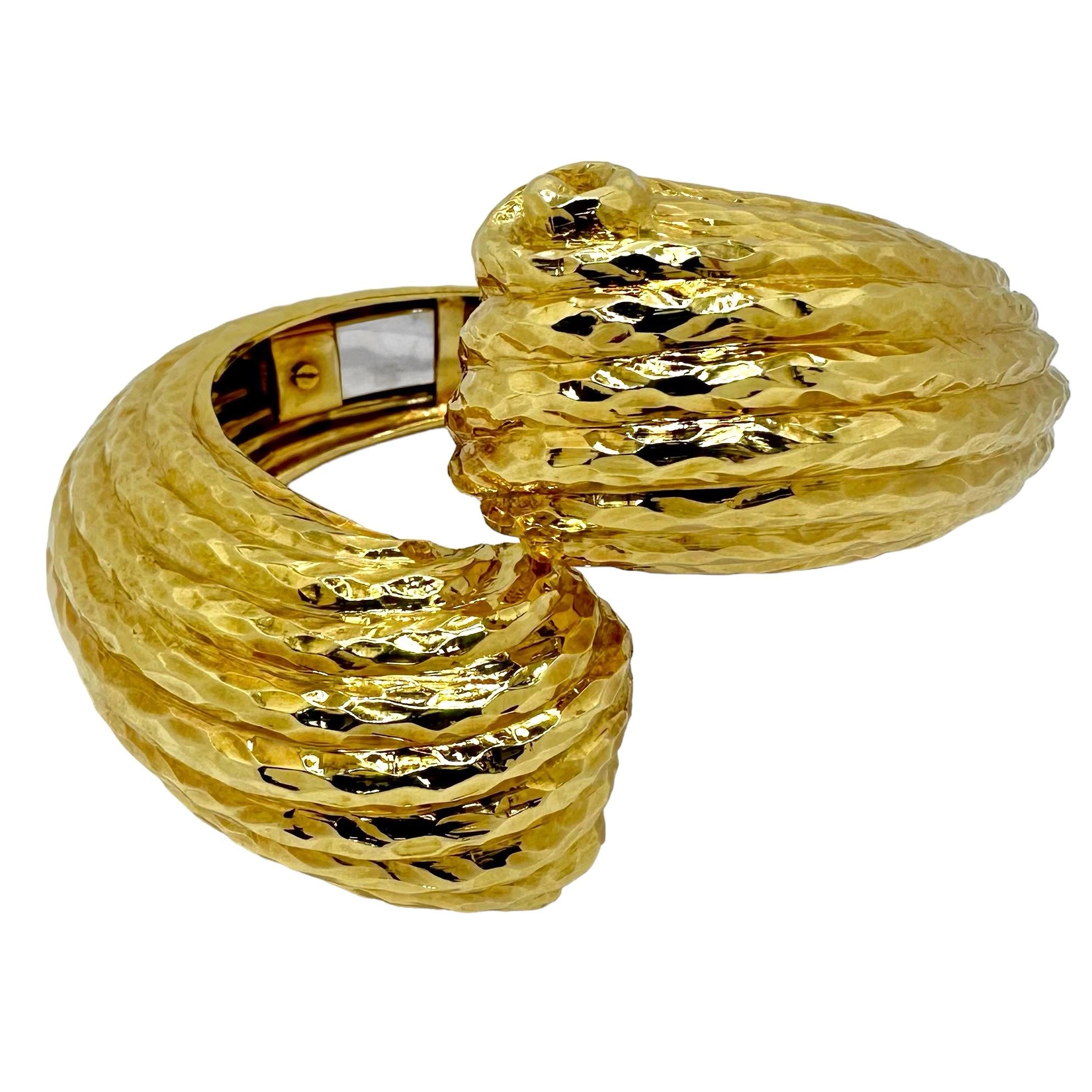 This massive and striking 18K yellow gold Italian cuff was manufactured during the Mid-20th Century, to the very highest standards of the gold crafting art. It is finished on all of it's frontal surfaces with a deeply chiseled, hammered finish. At