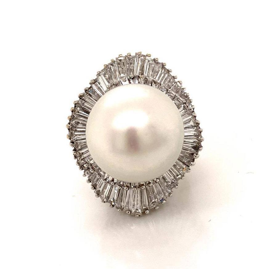 Wow! A magnificent ring featuring a natural 18mm South Sea cultured pearl! It has a lovely round shape which is difficult to achieve in such a large size. The rest of the ring is as unique as the pearl. There are 7 carats of tapered baguette cut