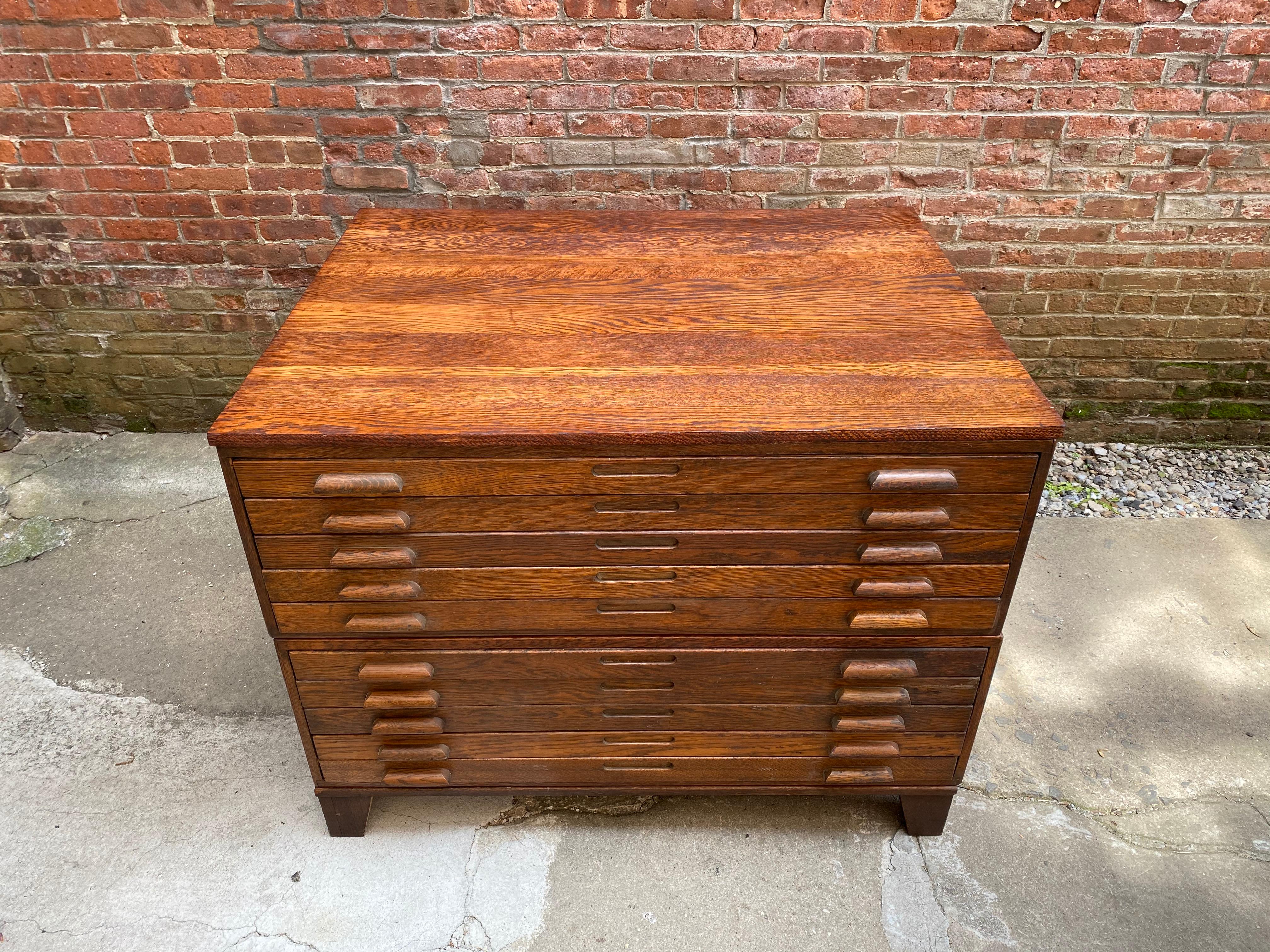 Solid oak construction with 10 flat drawers. The piece is comprised of two 5 drawer units that stack onto a sturdy footed base and a 