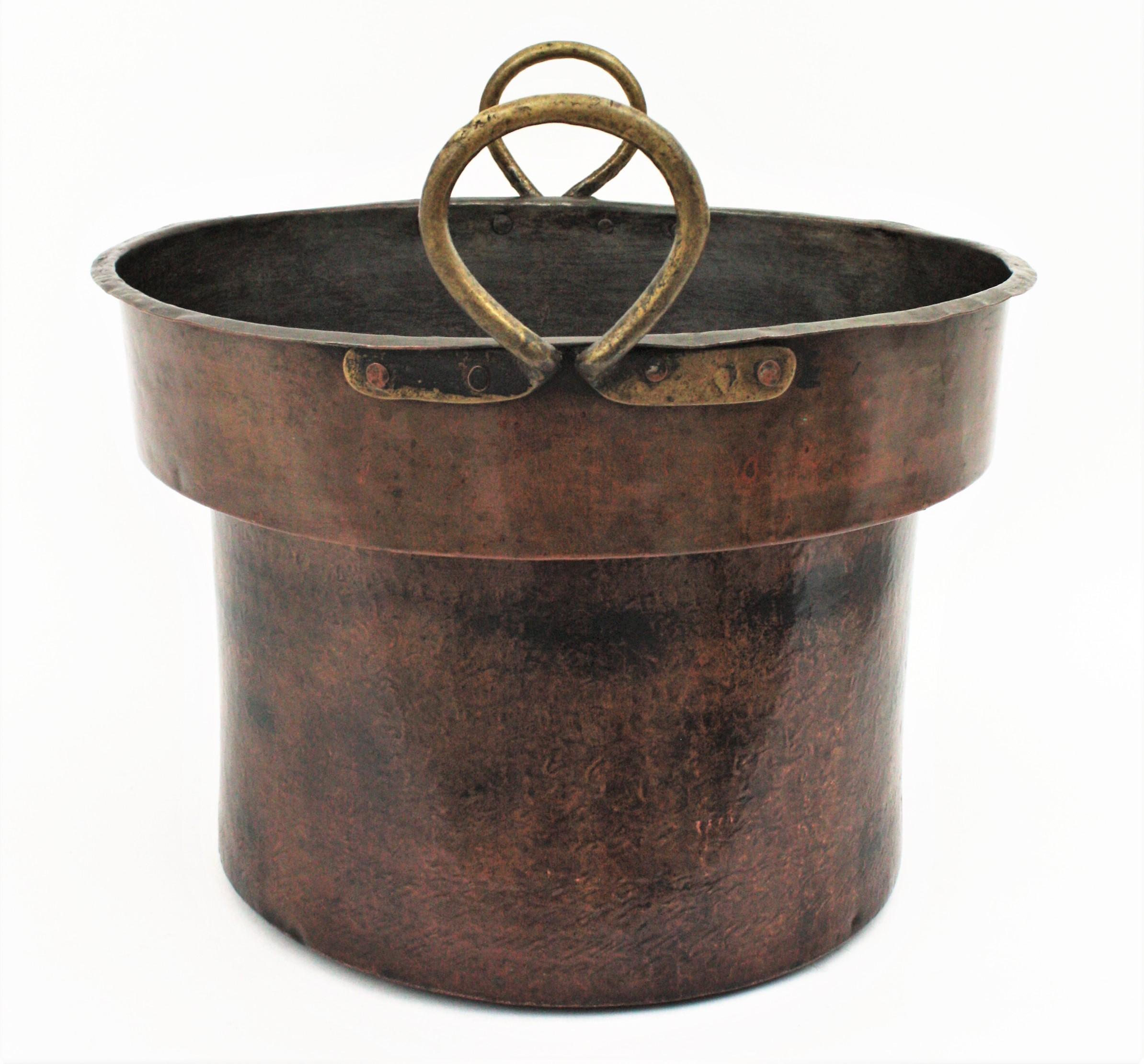 Oversized hand-hammered copper cauldron with brass handles, France, 1880s.
This beautiful handcrafted copper cauldron has a beautiful design and a dramatic aged patina.
Its large size allows to be used as log holder, decorative storage basket,