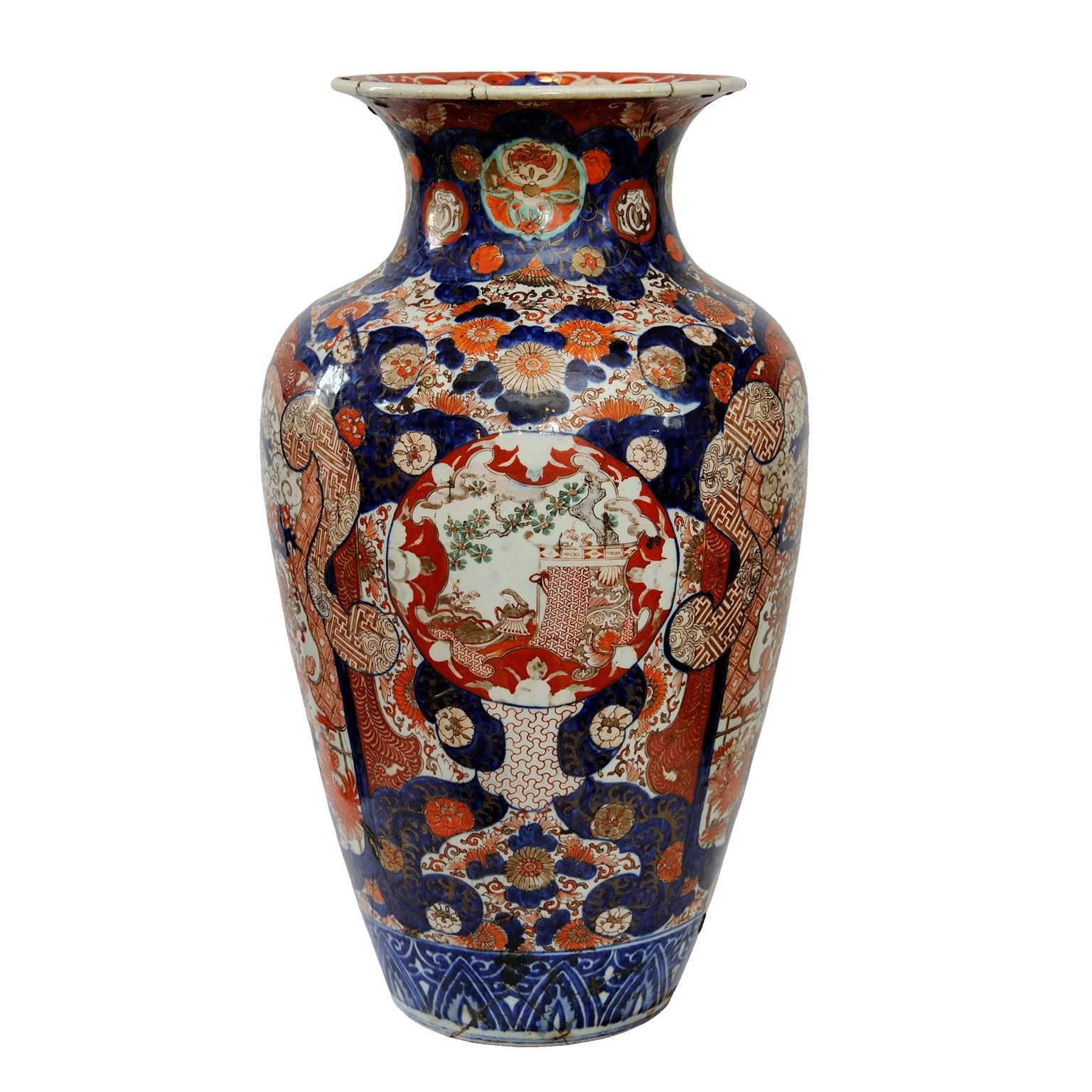 This is a massive and really rather beautiful, mid-19th century Japanese Imari vase, complete with old 19th century tinker staple repairs, circa 1840. 
A lovely piece with great charisma and presence.