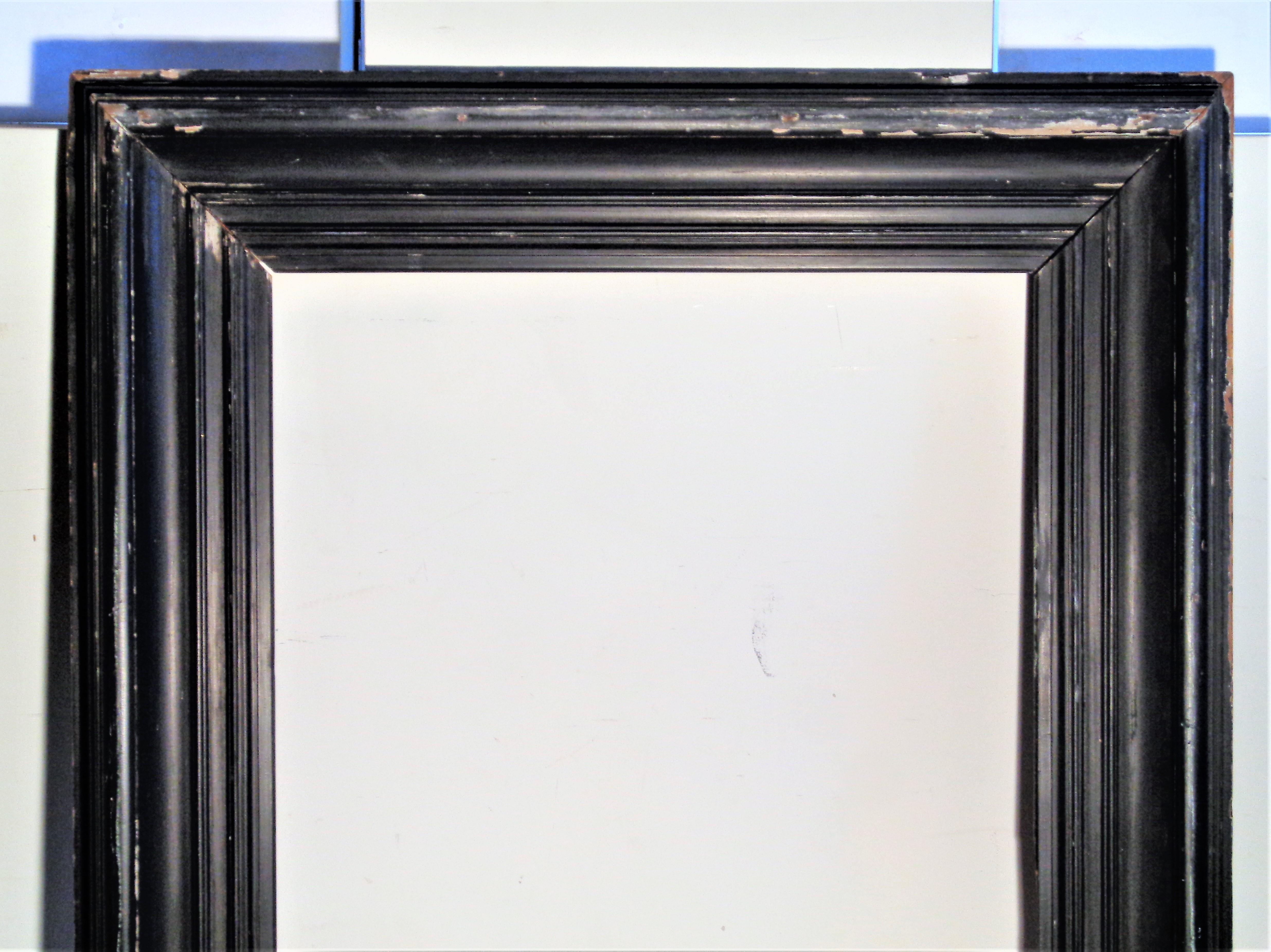 Massive 19th century wood frame with wide deep molding in older black painted surface with some areas of wear showing underlying gesso and bare wood. Great quality early construction. For a painting or a mirror. Lots of potential, would be great