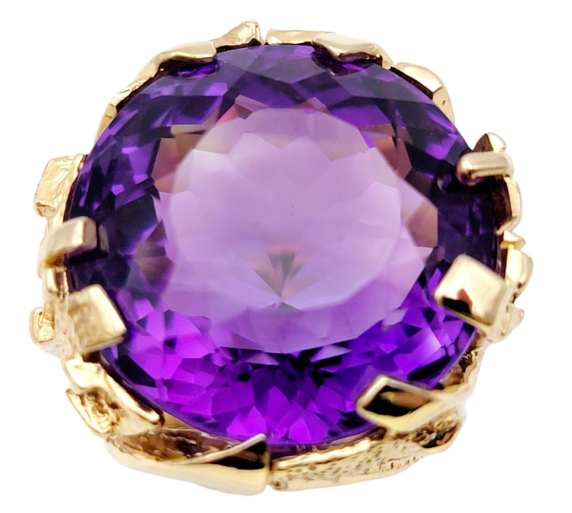 Ring size: 9

This ring is a truly spectacular statement piece filled with magnificent color, intricate detailing and a bold design. The huge round amethyst stone is multiple prong set in luxurious yellow gold with elaborate detail work along the