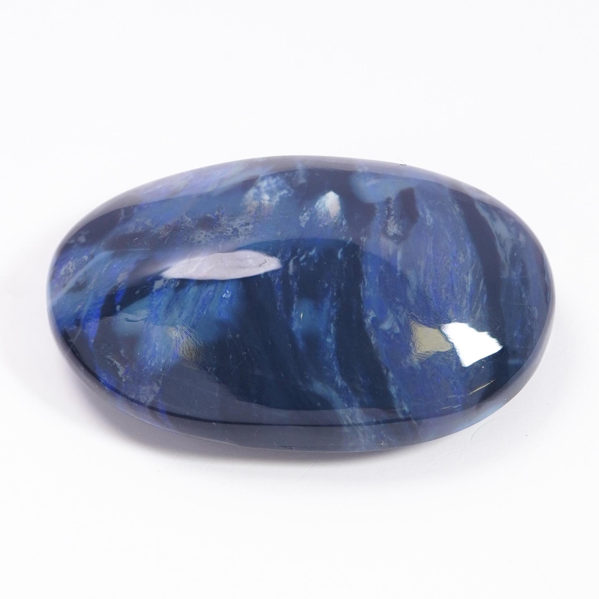 An extraordinary 56-carat Australian Black Opal, sourced from the renowned Lightning Ridge. This massive and rare gemstone is a true collector's treasure, celebrated for its mesmerizing play of color and exceptional size.

Exceptional Rarity and