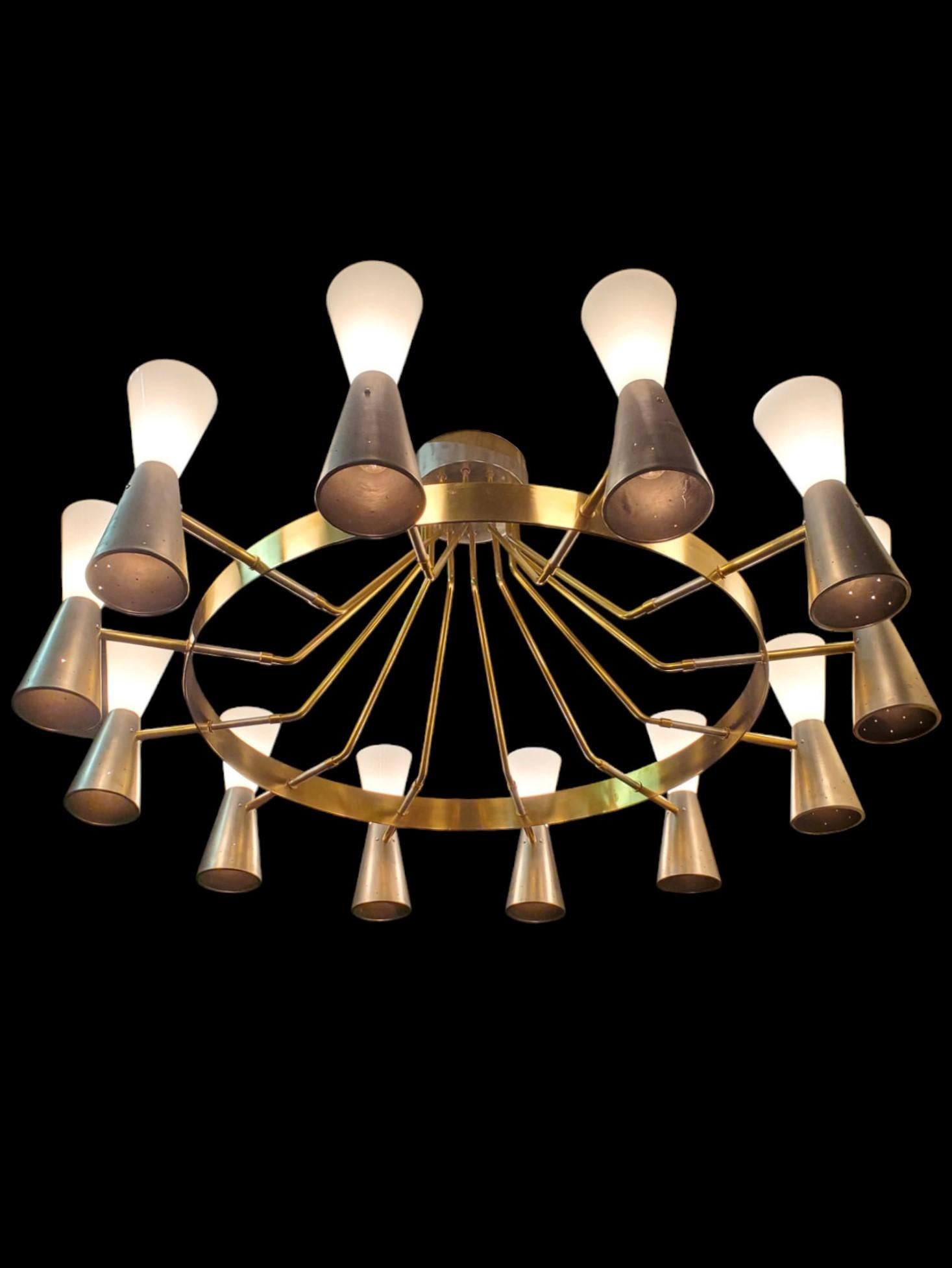 This imposing and majestic original Mid-century Modern chandelier features a substantial 
12-arm / 24-light design.
 A broad brass large ring supports double cone-shaped shades, with the upper shade casting  nice light through opaque white glass and