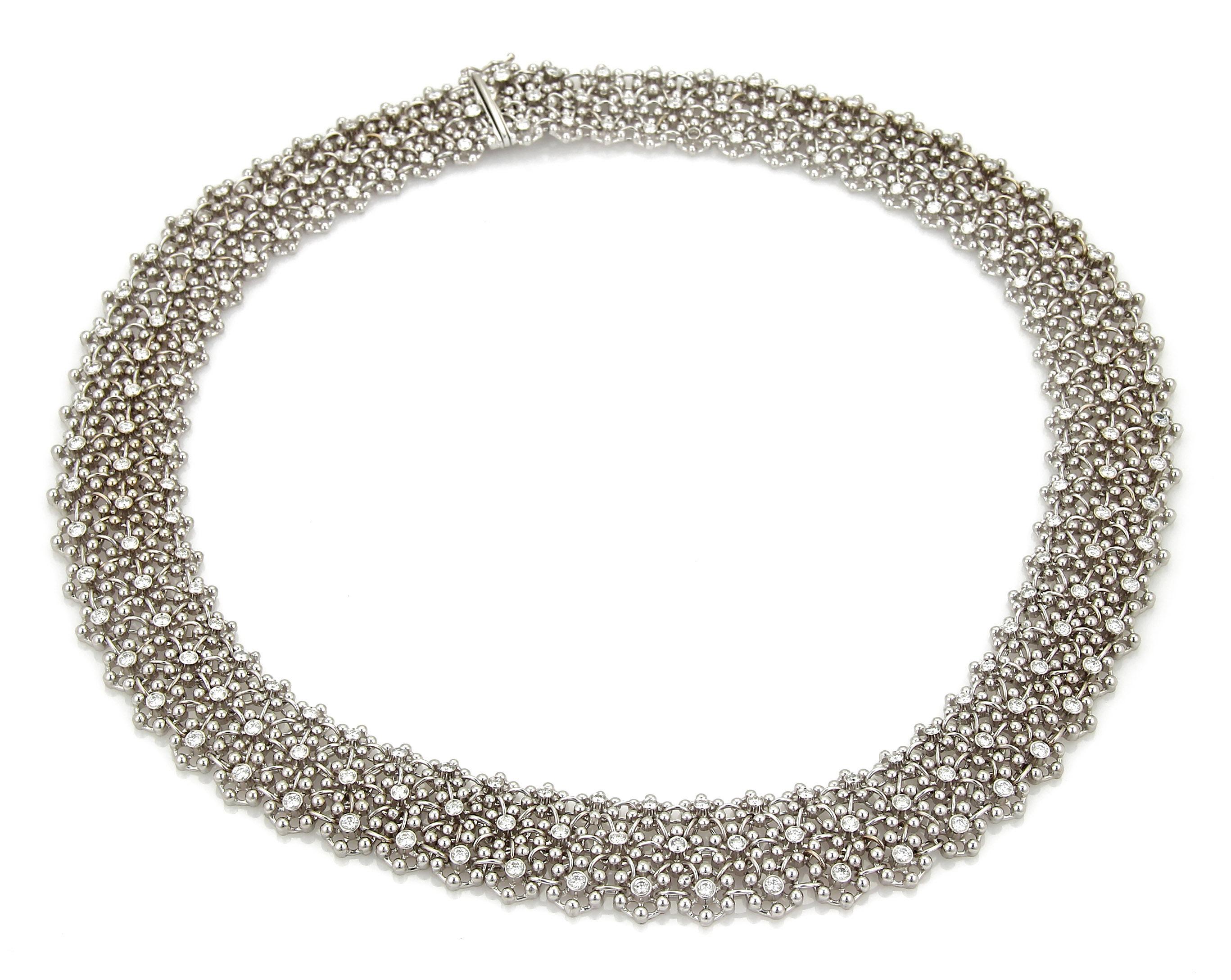 This is a stunning Estate lace design diamond necklace, it is crafted from 18k white gold with a fine polished finish. This amazing celebrity piece has rows of small beaded flowers joined together with a oval link creating a soft flexibility, the