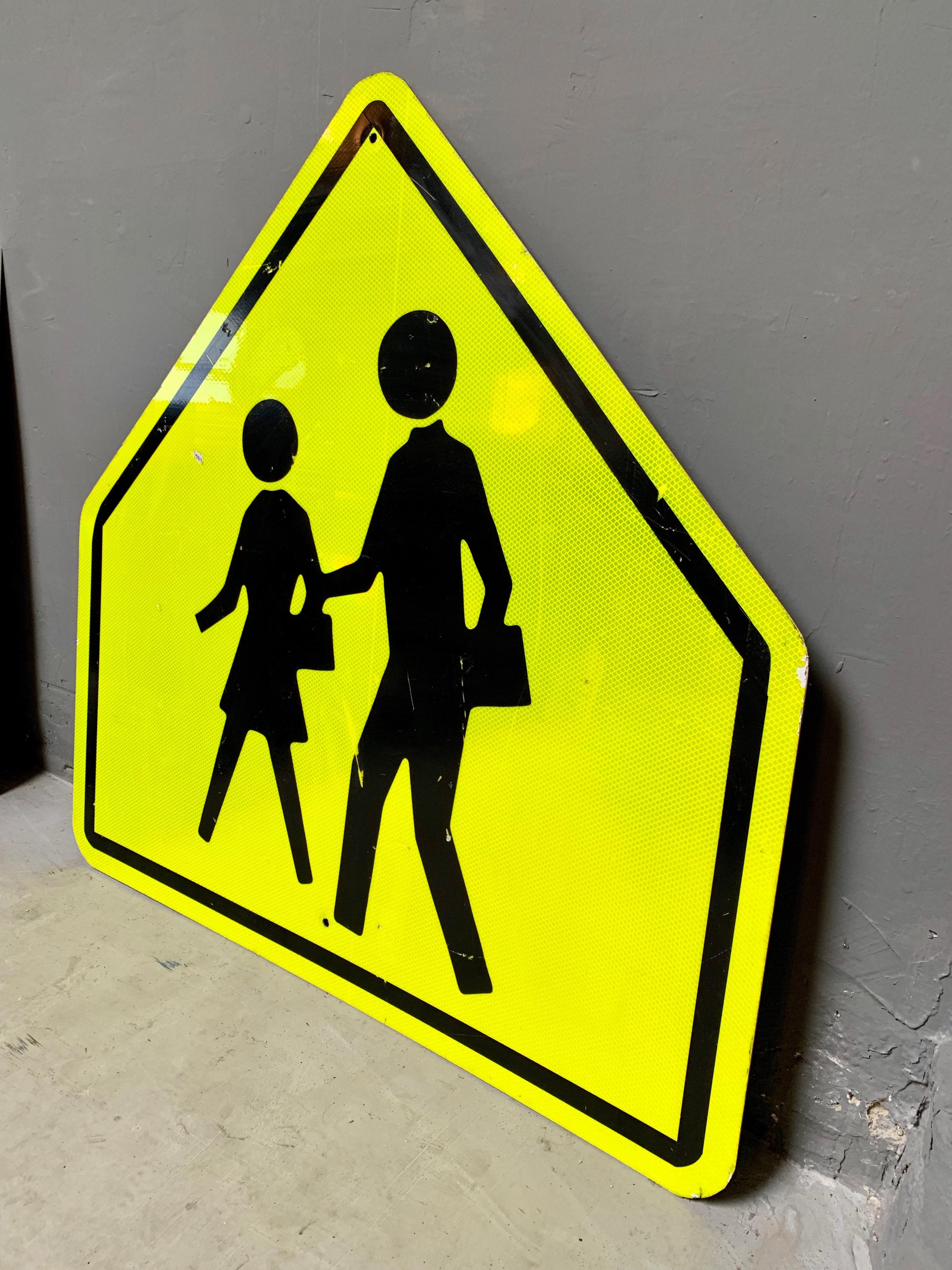 Massive acid yellow reflective road sign from the City of Los Angeles. Depicting a man and woman crossing the road. Good vintage condition.

 