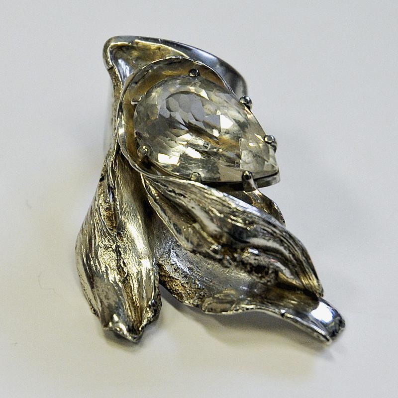 Massive, beautiful and majestic Swedish mid-century modern silver ring that really catches your eye! Designed and made by mid-century designer Inga Lagervall (1943-). Stockholm, Sweden 1977. Brutalist style with a nicely placed teardrop shaped clear