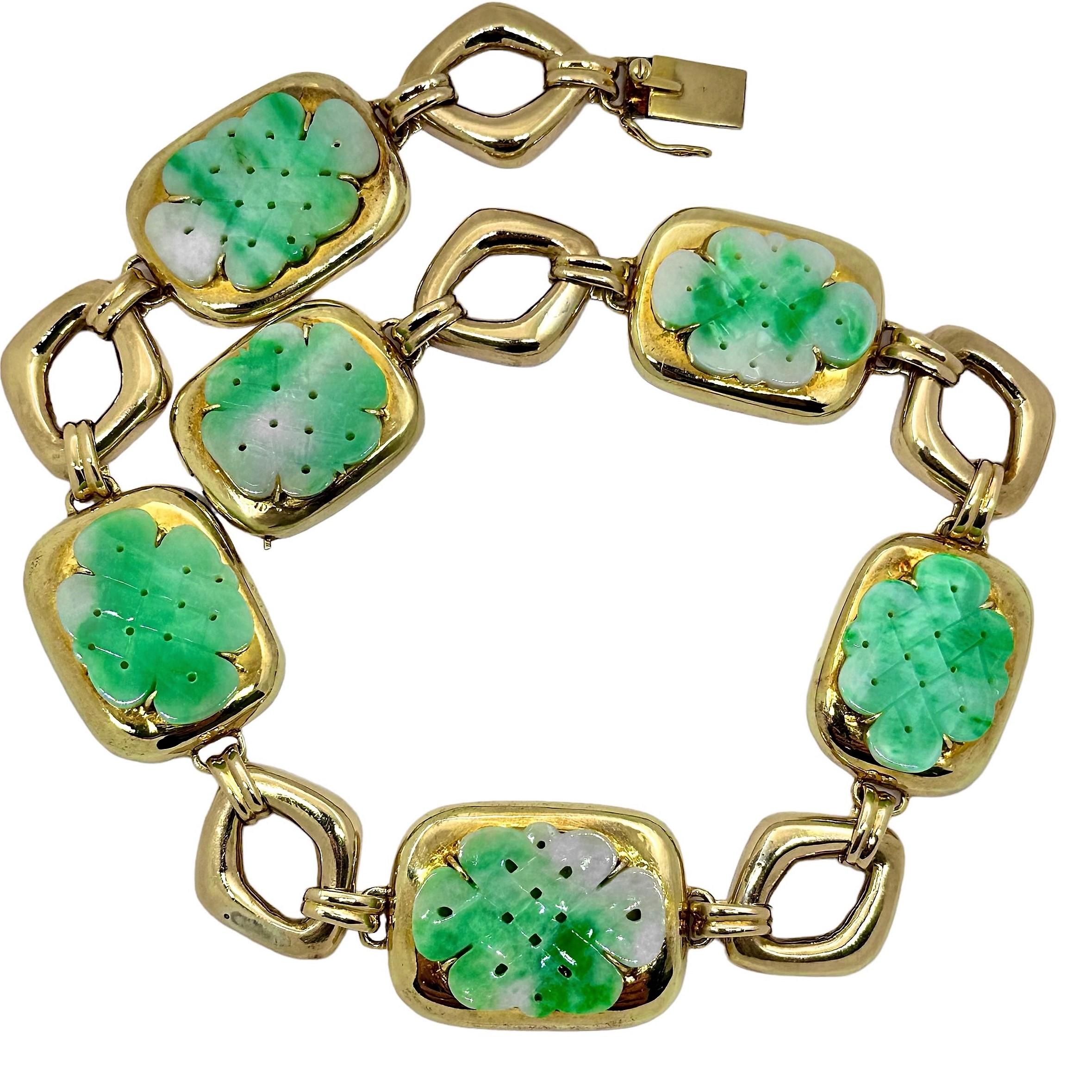 This massive 18K yellow gold Mid-20th Century choker necklace is mounted with six large and intricately hand carved and pierced,  jadeite jade panels. Each piece exhibits vibrant green tones, and the affect is beyond striking. The center panel is