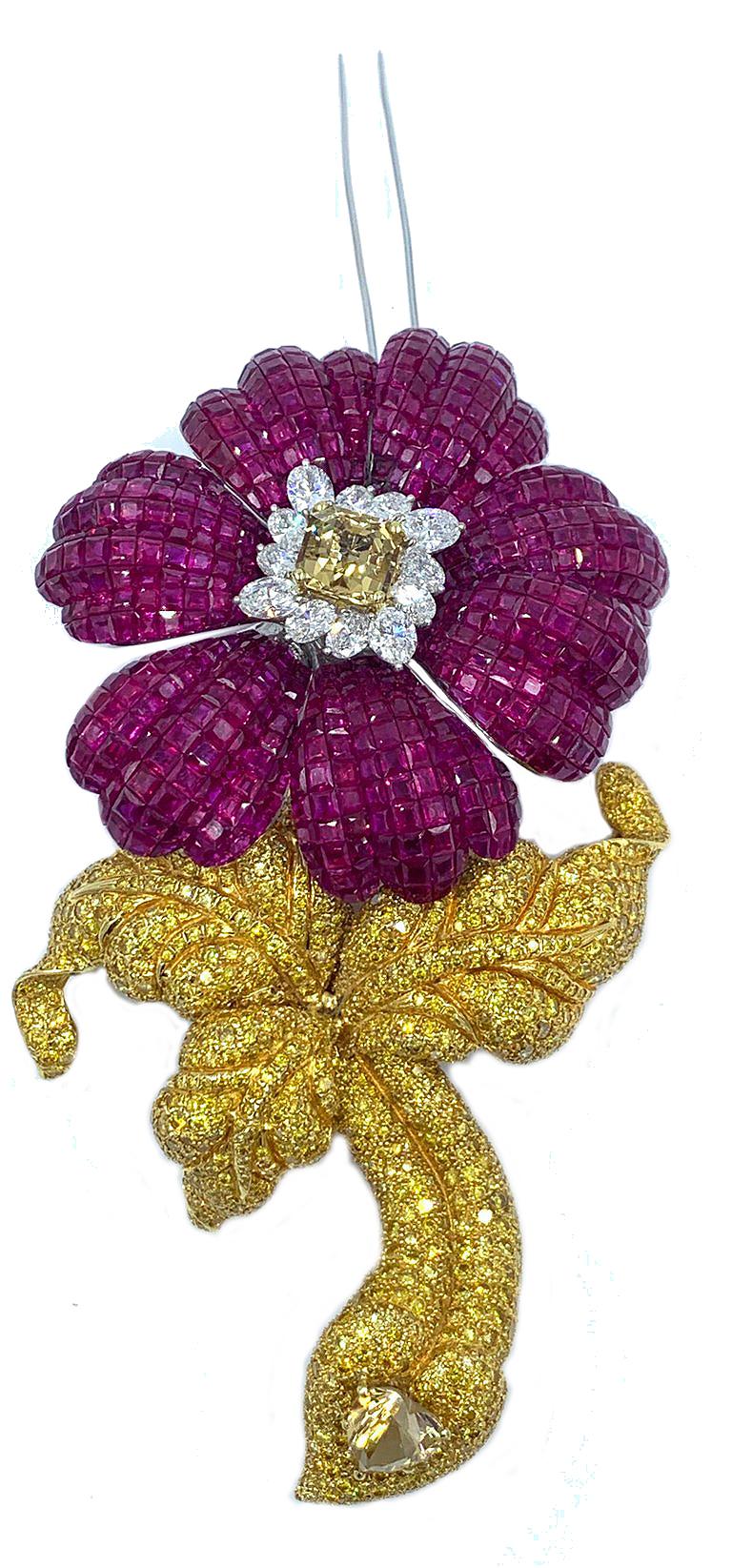 This massive and fabulously over the top ruby  and canary diamond flower brooch with removable stem contains approximately 100 carats of glistening red rubies in the flower part.  The flower is centered with a citrine surrounded by 4 carats of