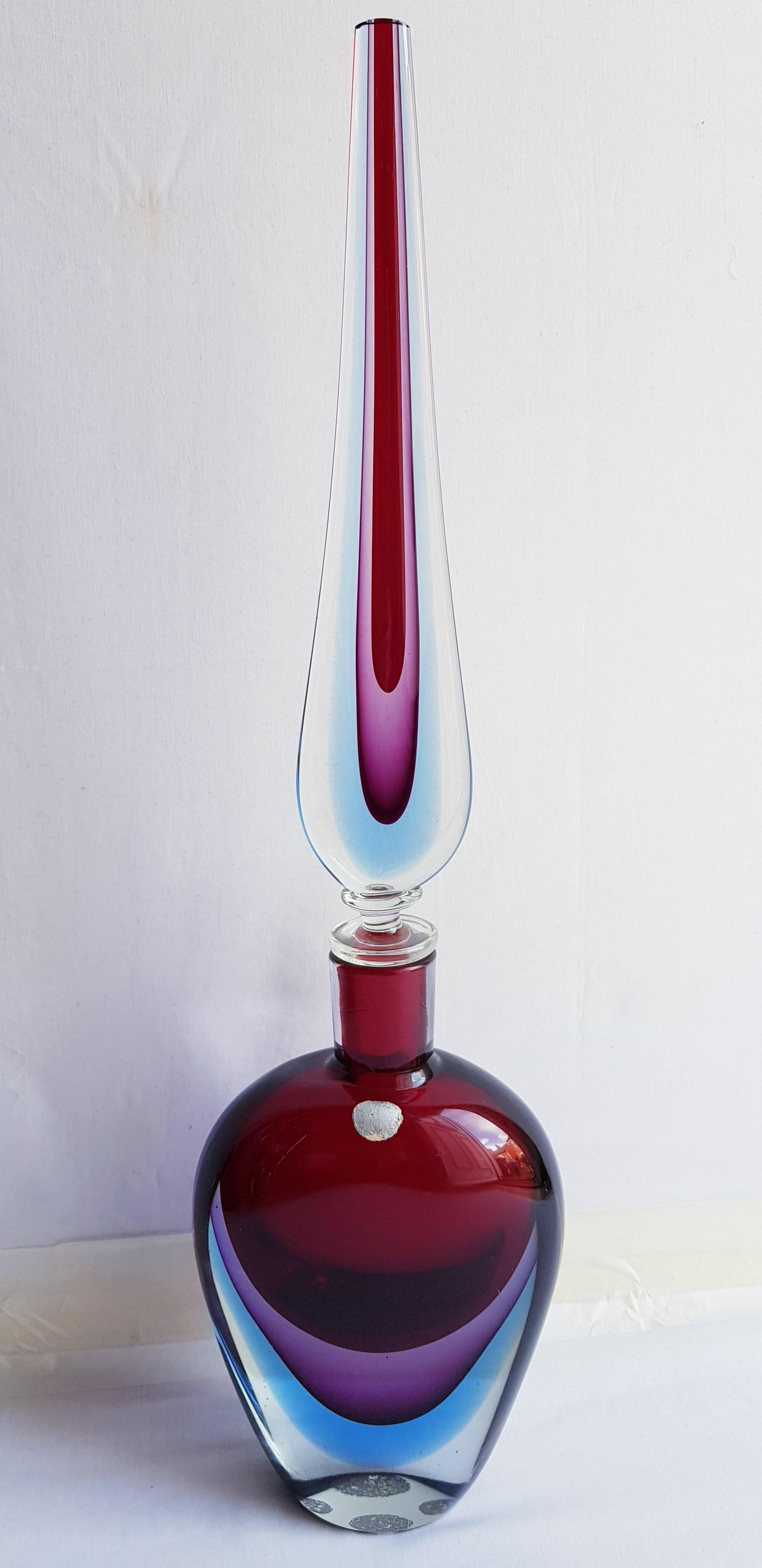 Beautiful antique murano glass large triple somerso Bottle with stopper, red,purple, blue and clear by Flavio Poli for Seguso with original Import sticker brilliant condition. Measure: 52cm. Note: the Bottle have 25 cm tall and stopper have 32 cm