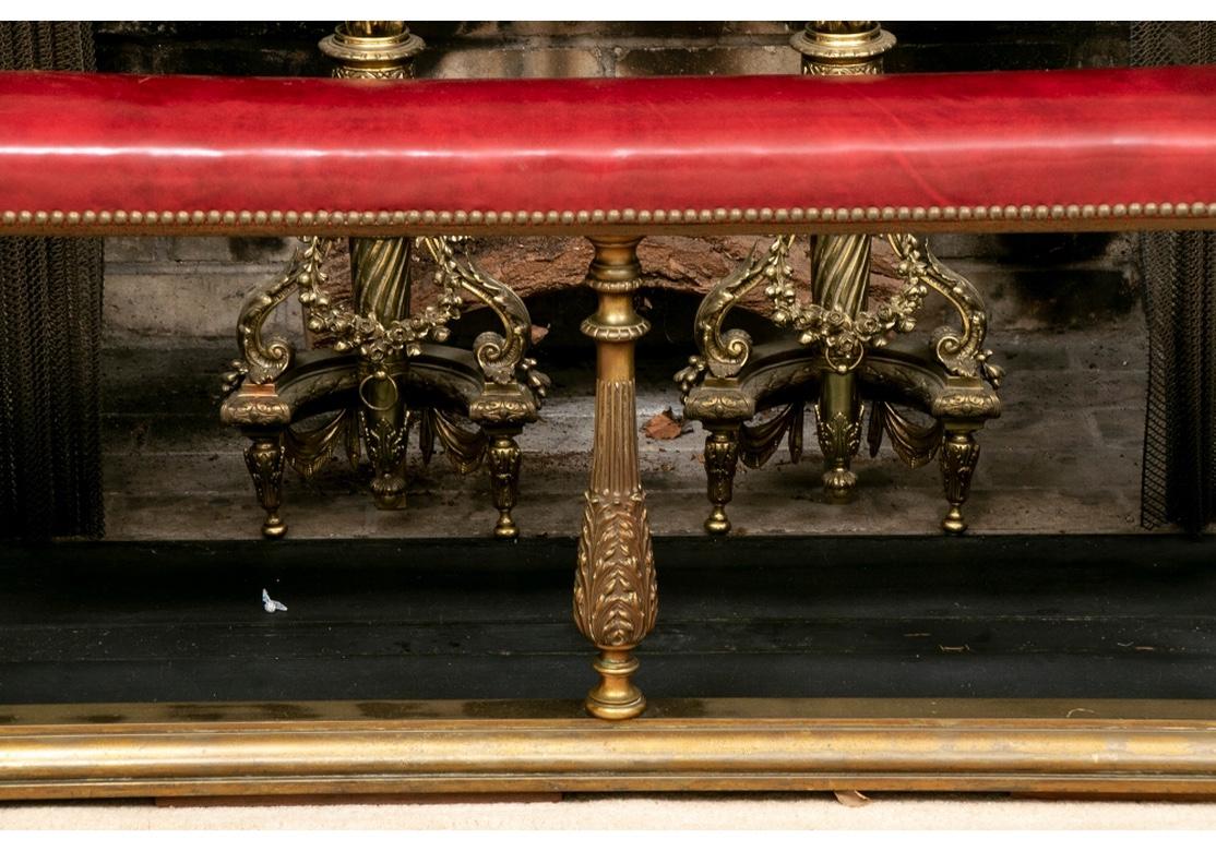 A large scale U shaped fender with fine cast brass frame. The long side with five baluster form brass supports with beaded tops, and ribbed and leafy details below. Two others support the back on the short sides. All mounted on a curved brass base.