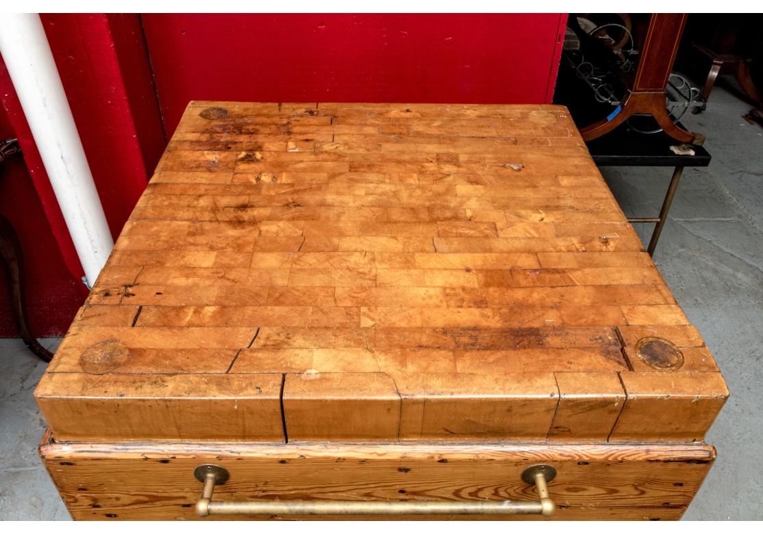 A large and very well made Antique Butcher Block Island with thick turned legs, wide Pine apron boards with good graining, castors, Brass  towel bar (likely a later addition)  and a fantastic honey toned Maple top traditionally  sectioned in pieces