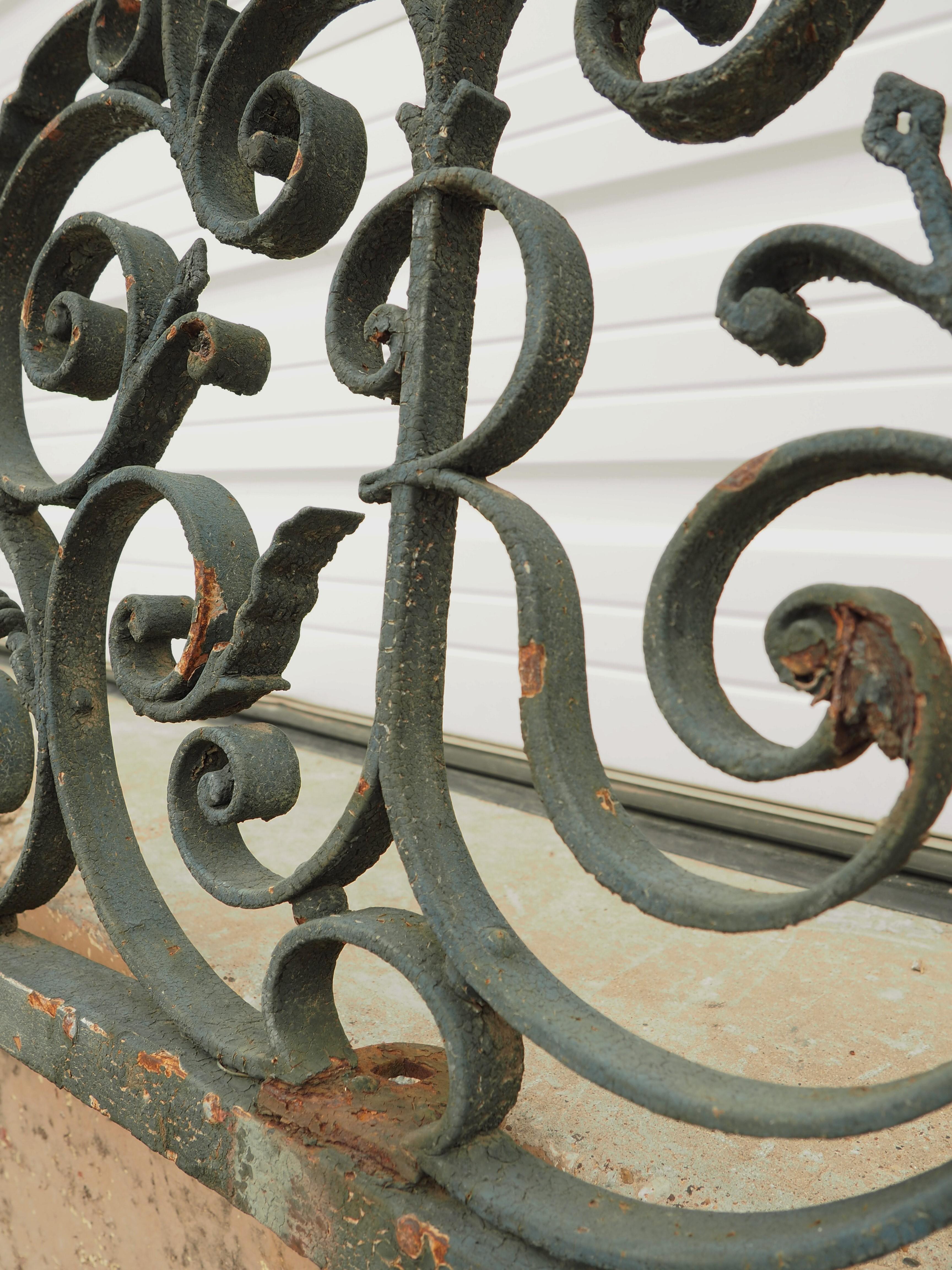 Standing at almost seven feet tall and over 12 feet wide, this wrought iron gate transom is quite impressive. A transom is a horizontal architectural element, in this case, one that would have gone above a gate opening. The iron, which has been