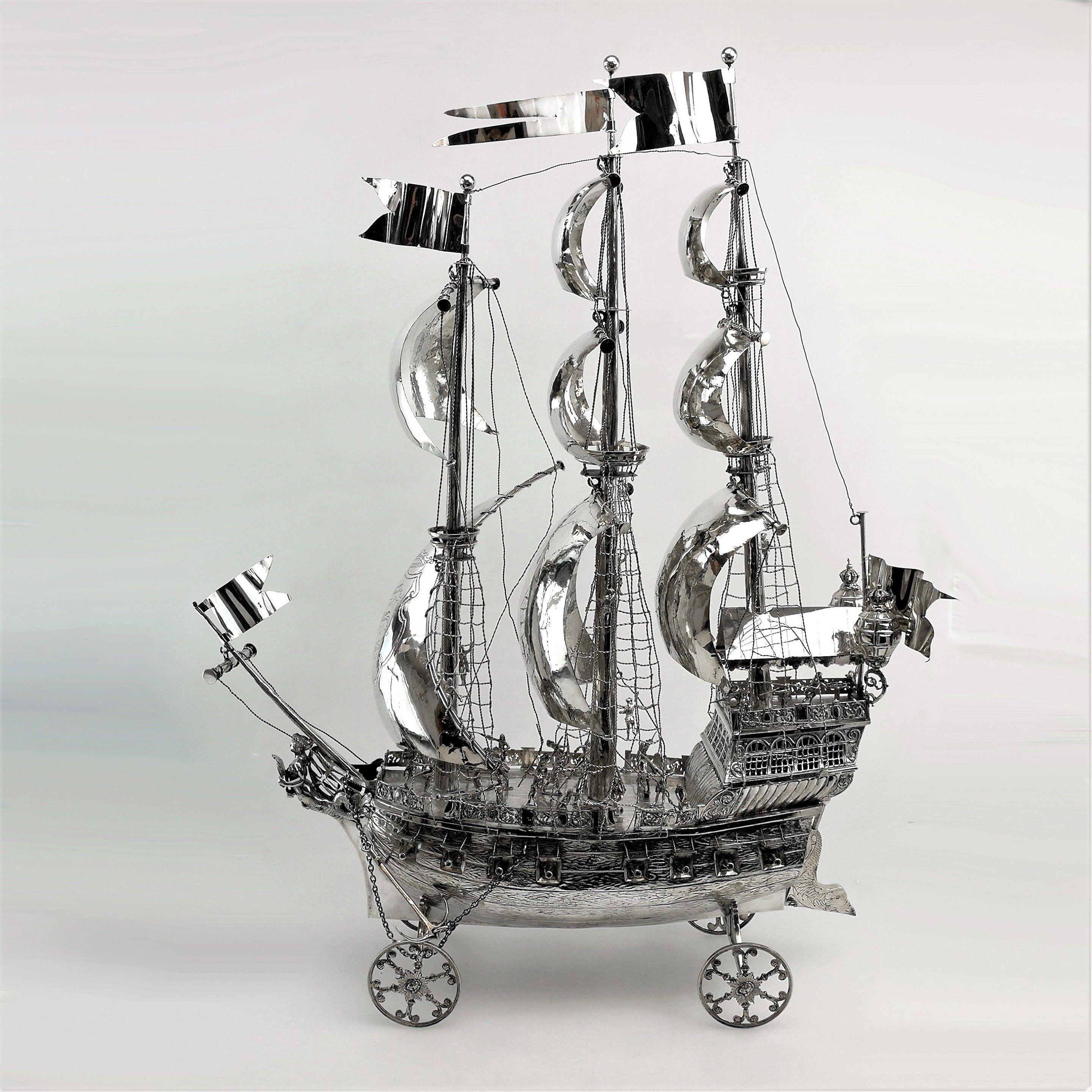 A magnificent Antique solid Silver Nef made by German Silversmith Berthold Muller mirroring the historically traditional style of Nefs. This is a particularly large example of a Nef - a Sailing Boat or Galleon Ship shown in full sail. The Ship is