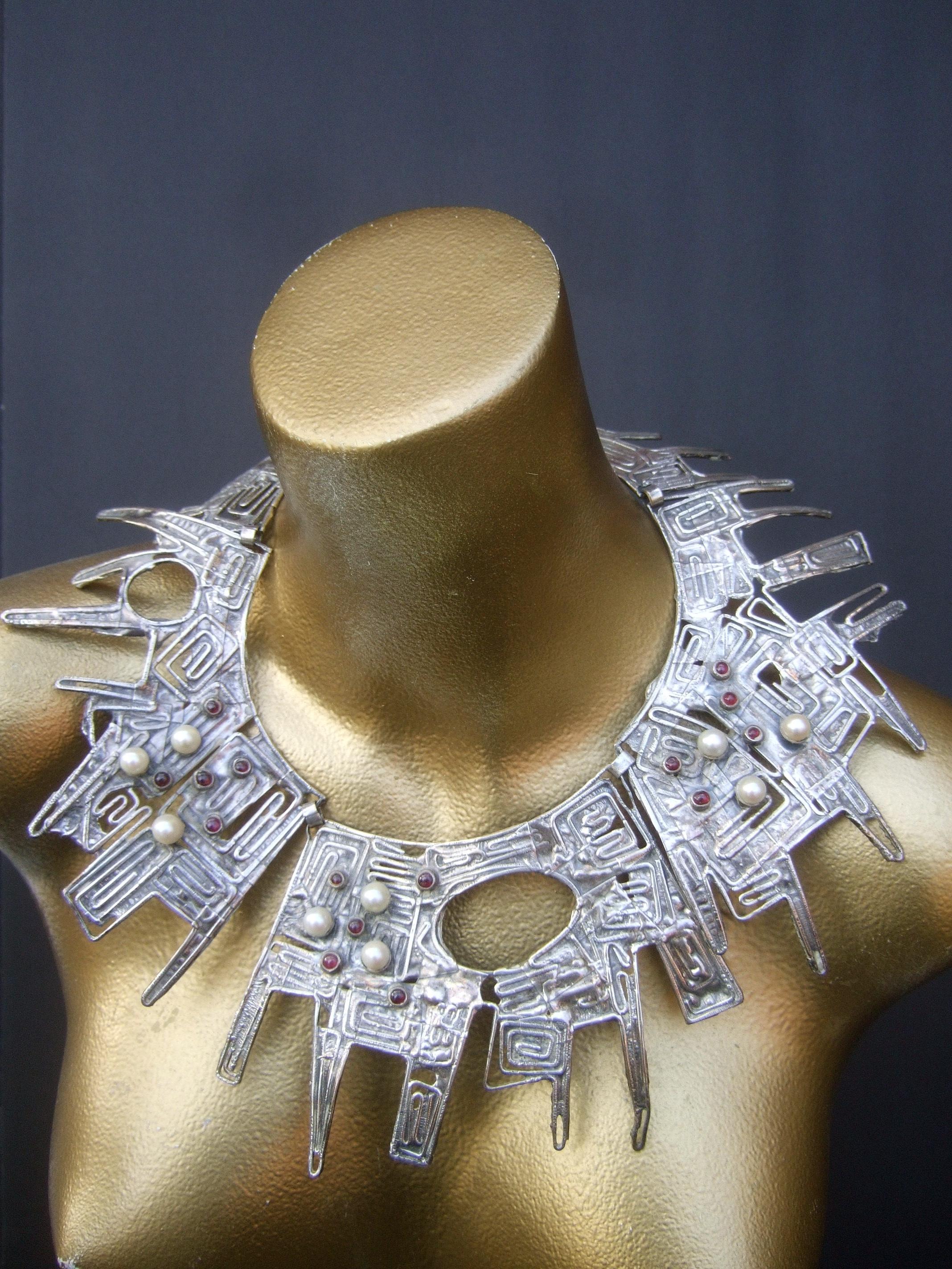 Massive avant-garde sterling silver brutalist statement necklace designed by Rachel Gera c 1970s

The incredible mind-boggling massive scale sterling silver artisan necklace is comprised of three huge scale sterling silver brutalist hinged panels;