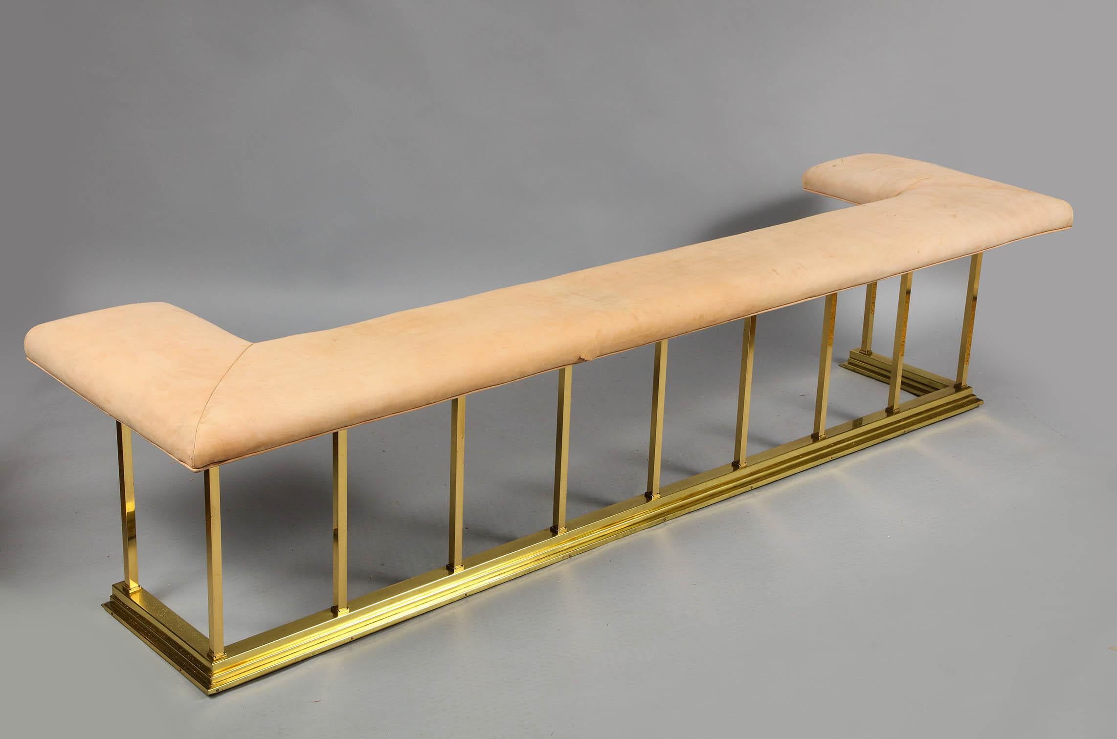 Fine early 20th century heavy gauge brass club fender, currently upholstered in as found buck suede, having square brass supports over molded brass bottom rail with wrought and cast iron framing of unusually large scale. Ready for