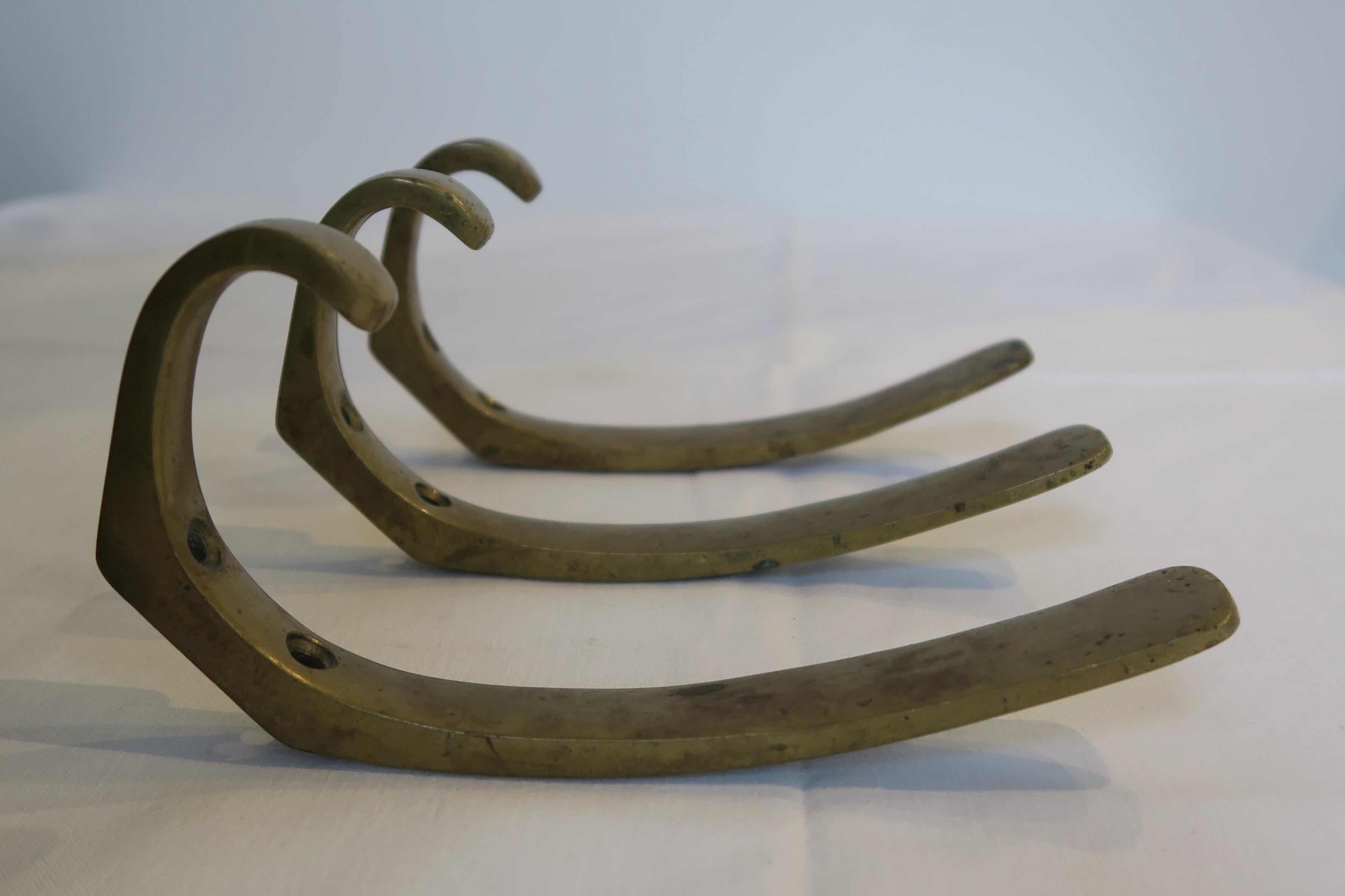 For sale is a set of 3 coat hooks in the style of either Walter Bosse, Herta Baller or Carl Auböck. They are made of massive brass and were produced in Austria in the 1950s. They are an iconic piece of Austrian design and craftsmanship. Each hook
