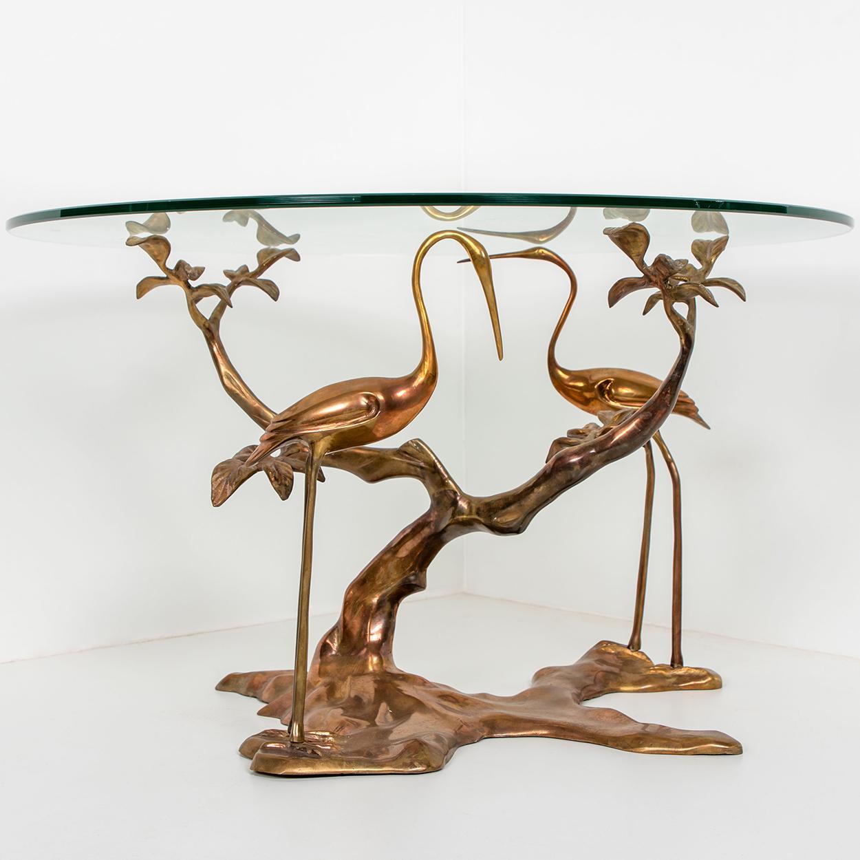 Stunning brass coffee table. With two bird shapes in full brass. The brass base and table top is in very good condition. The pictures show the original, old aged state. It gives the piece character. But if requested, it can be polished by us, to