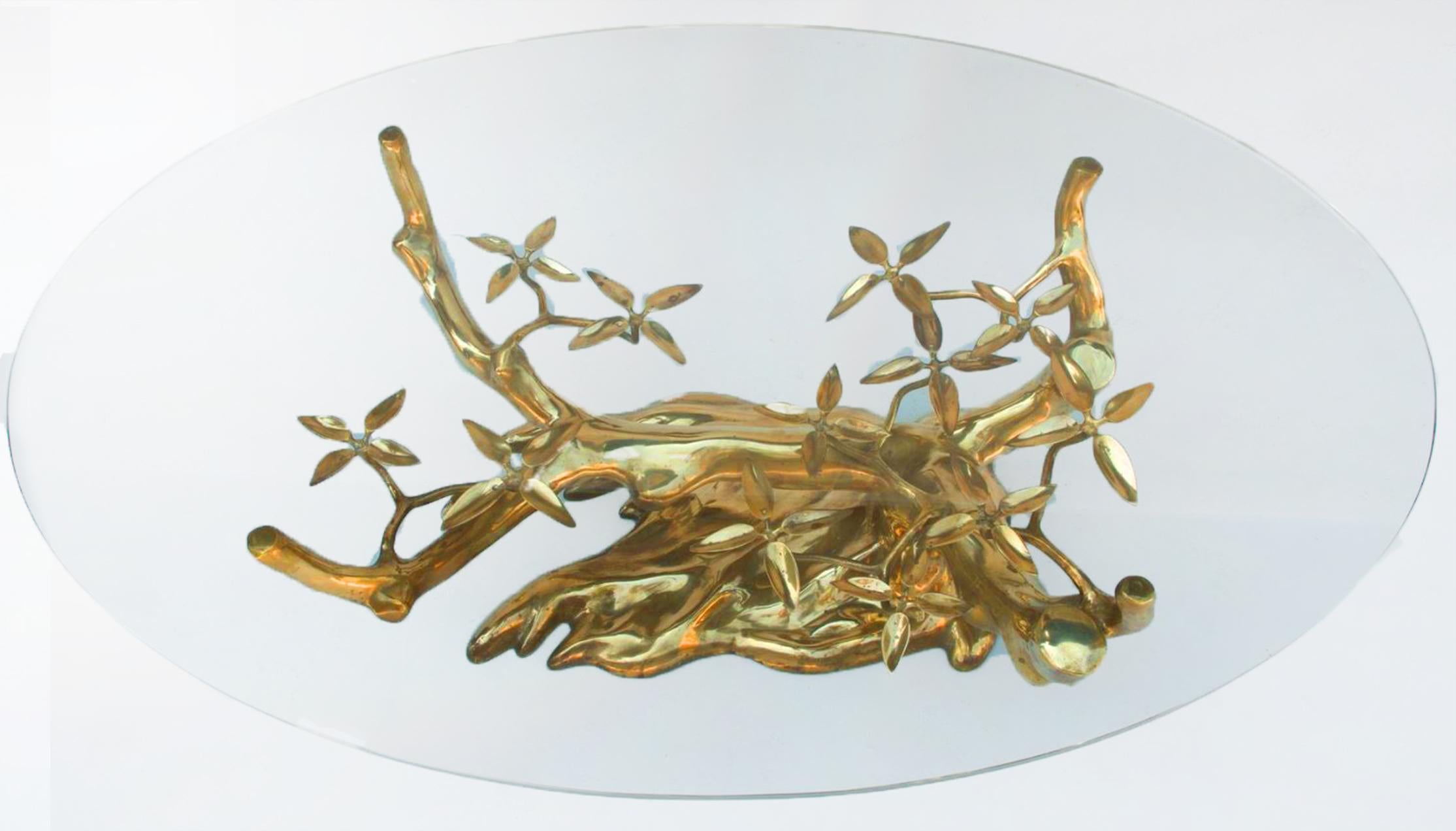 Stunning brass coffee table. Organic shaped. Brass is in very good and clean condition, the glass top is also in very good condition. This is a fantastic work of art. 

This coffee table is positioned as a sculpture in a living room or reading